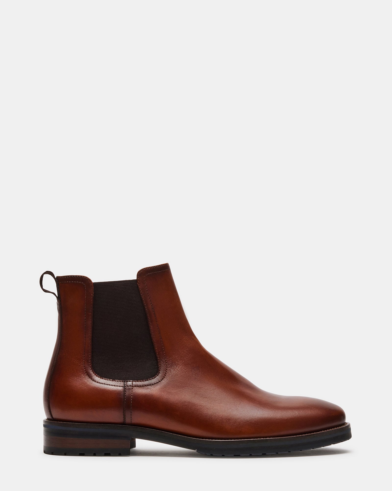 Front view of SYRE tan leather pull-on boots on a city street