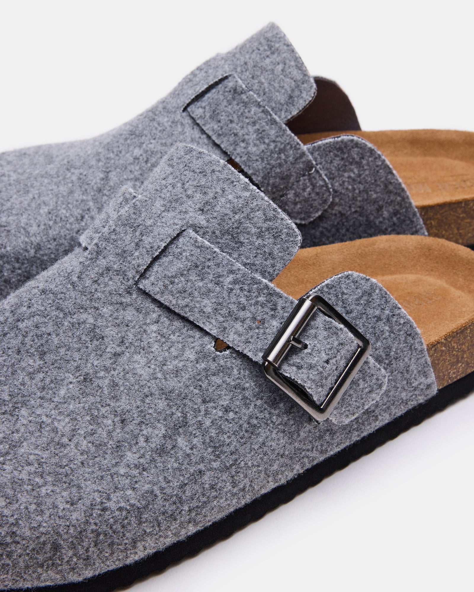 Side view of the shoes highlighting the 1-inch heel and synthetic sole design.