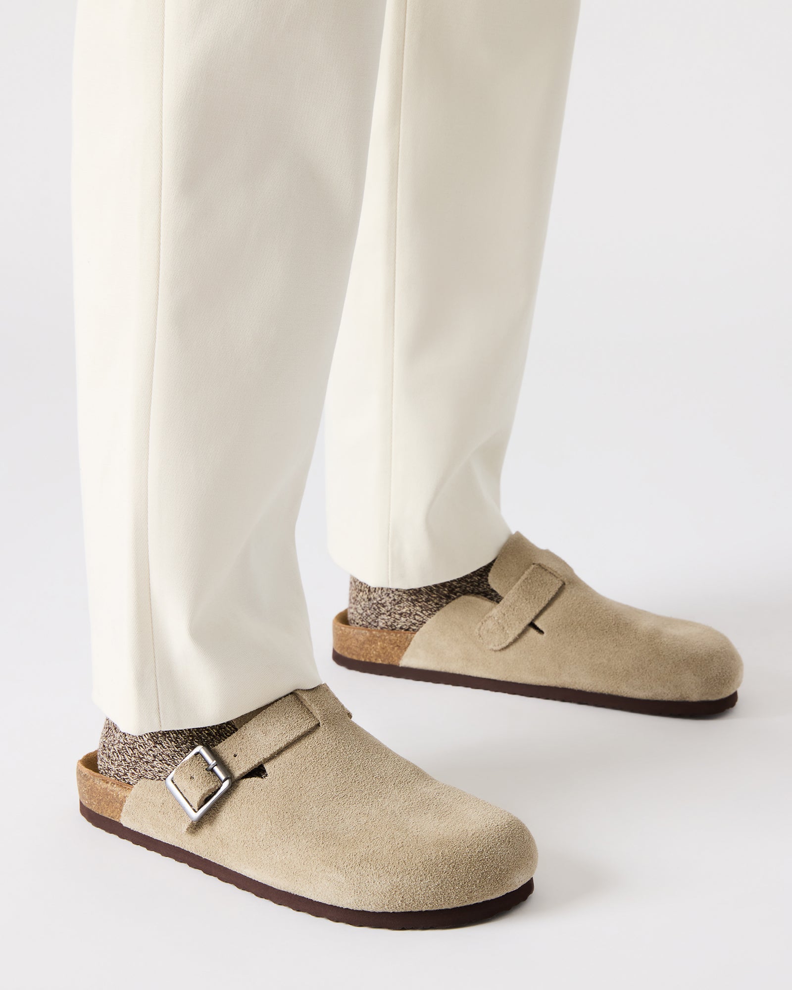 Side view of the shoes highlighting the 1-inch heel and synthetic sole design.