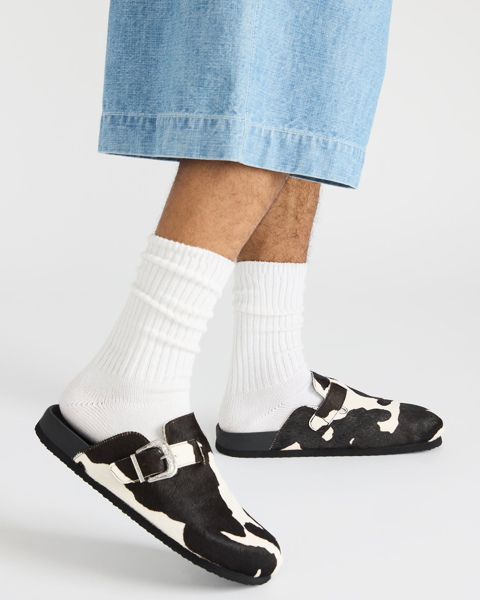 Side view of the WOOLY Black Multi mens slip-on shoes highlighting the leather upper