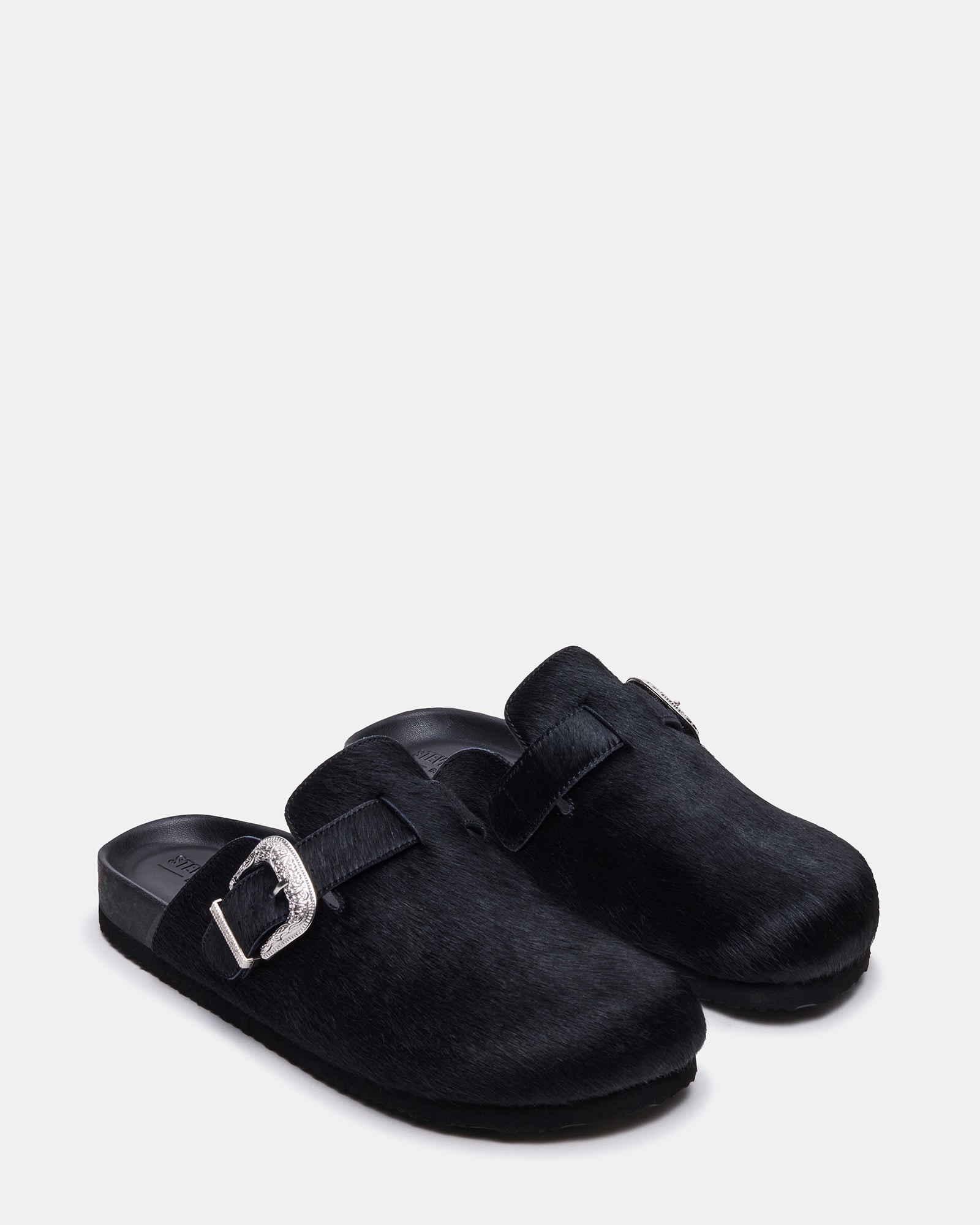 Close-up of western buckle detail on casual loafers