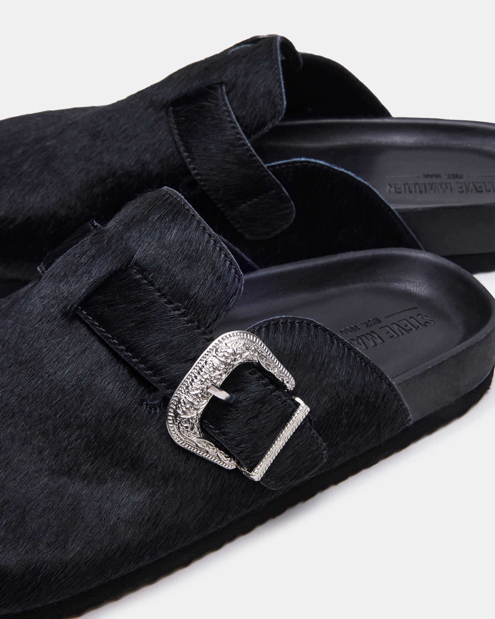 Pair of Wooly Black shoes on wooden floor lifestyle shot