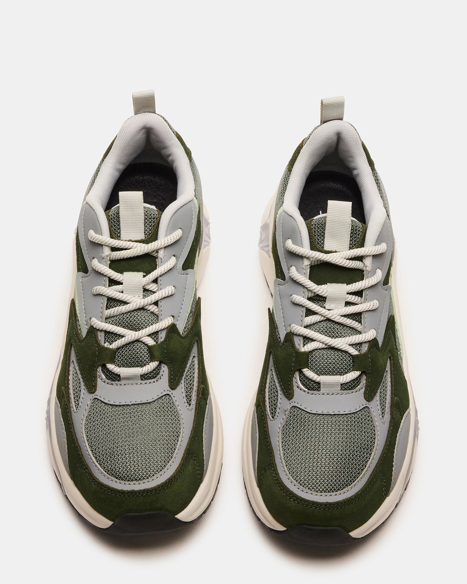 Close-up of the lace-up design on brown suede sneakers, highlighting quality craftsmanship.