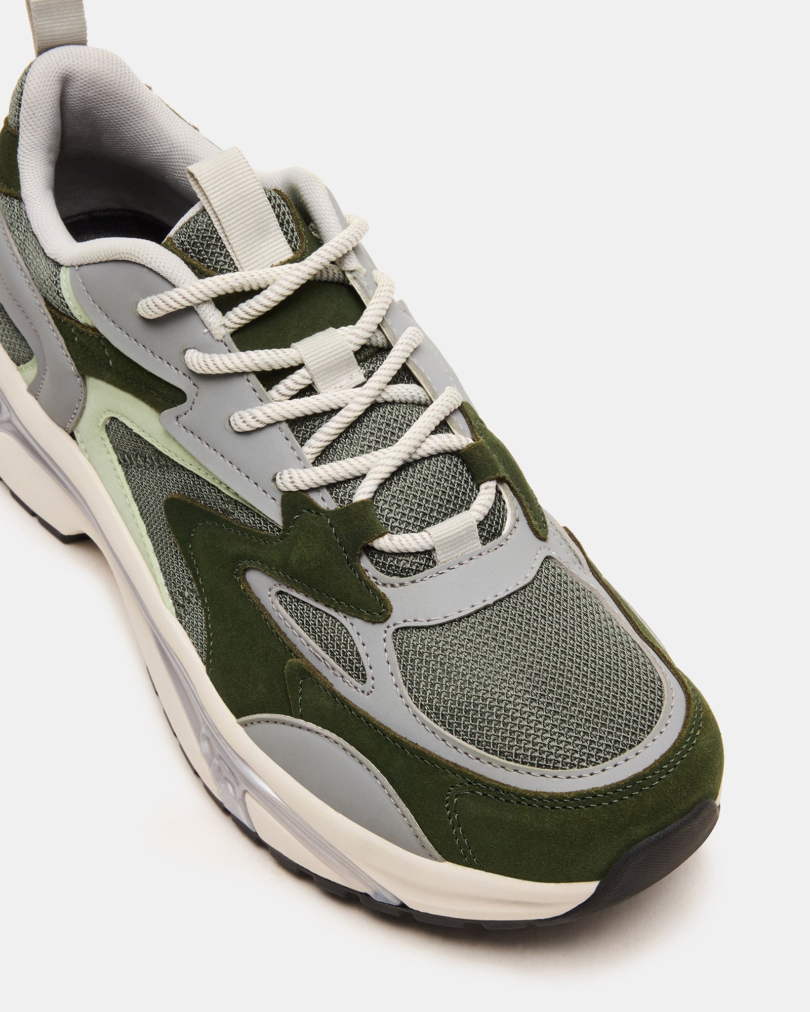 Stylish green low-top suede sneakers showcased from the side, ideal for daily wear.
