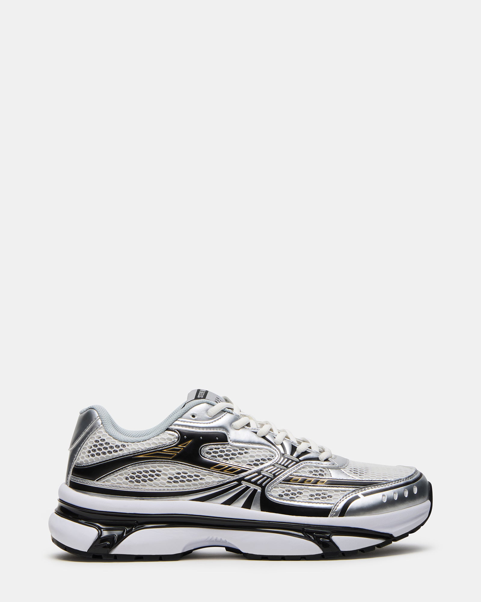Side view of Yuval black/silver low top sneakers on concrete pavement