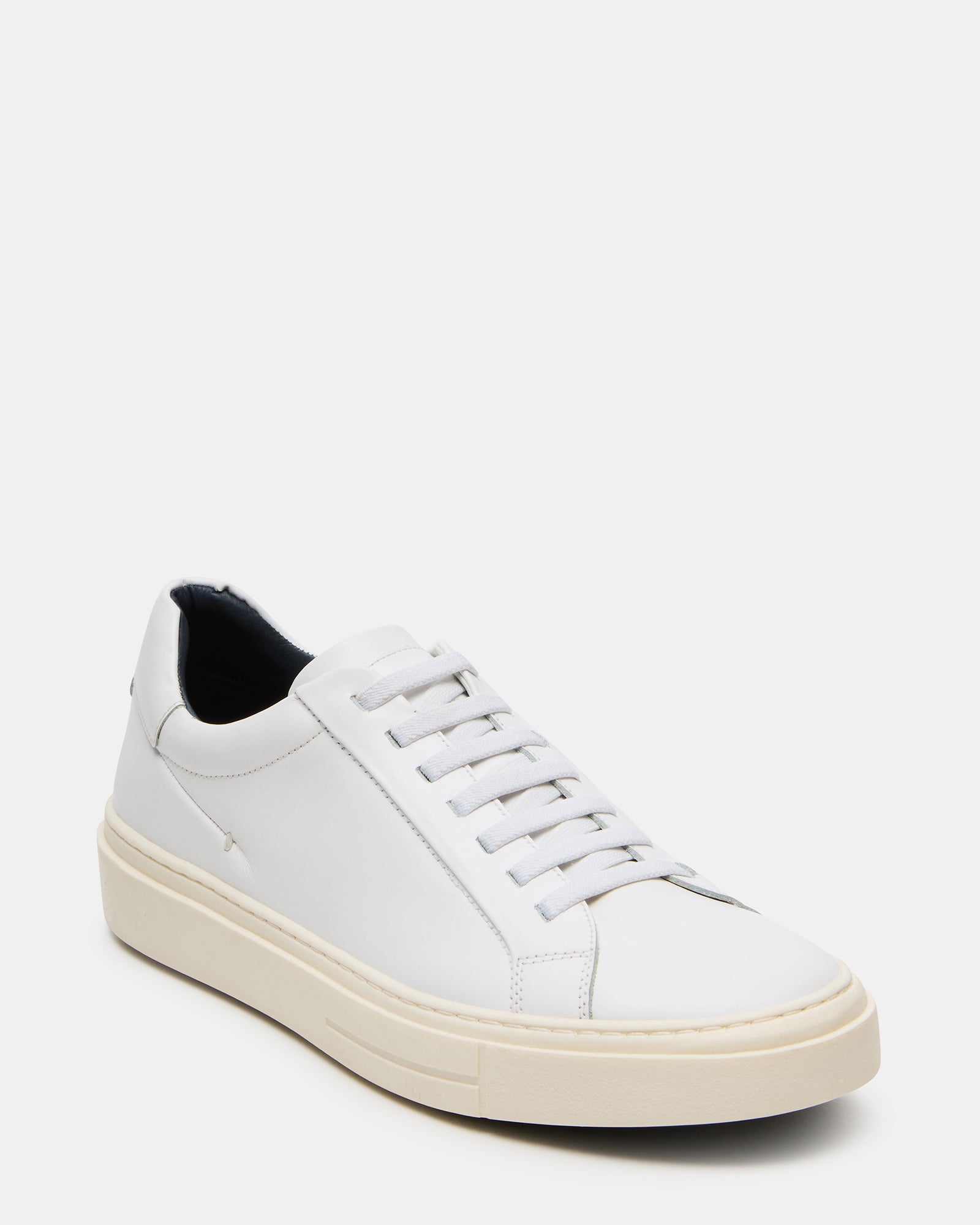 Fashionable white leather sneakers paired with casual clothing for daily wear