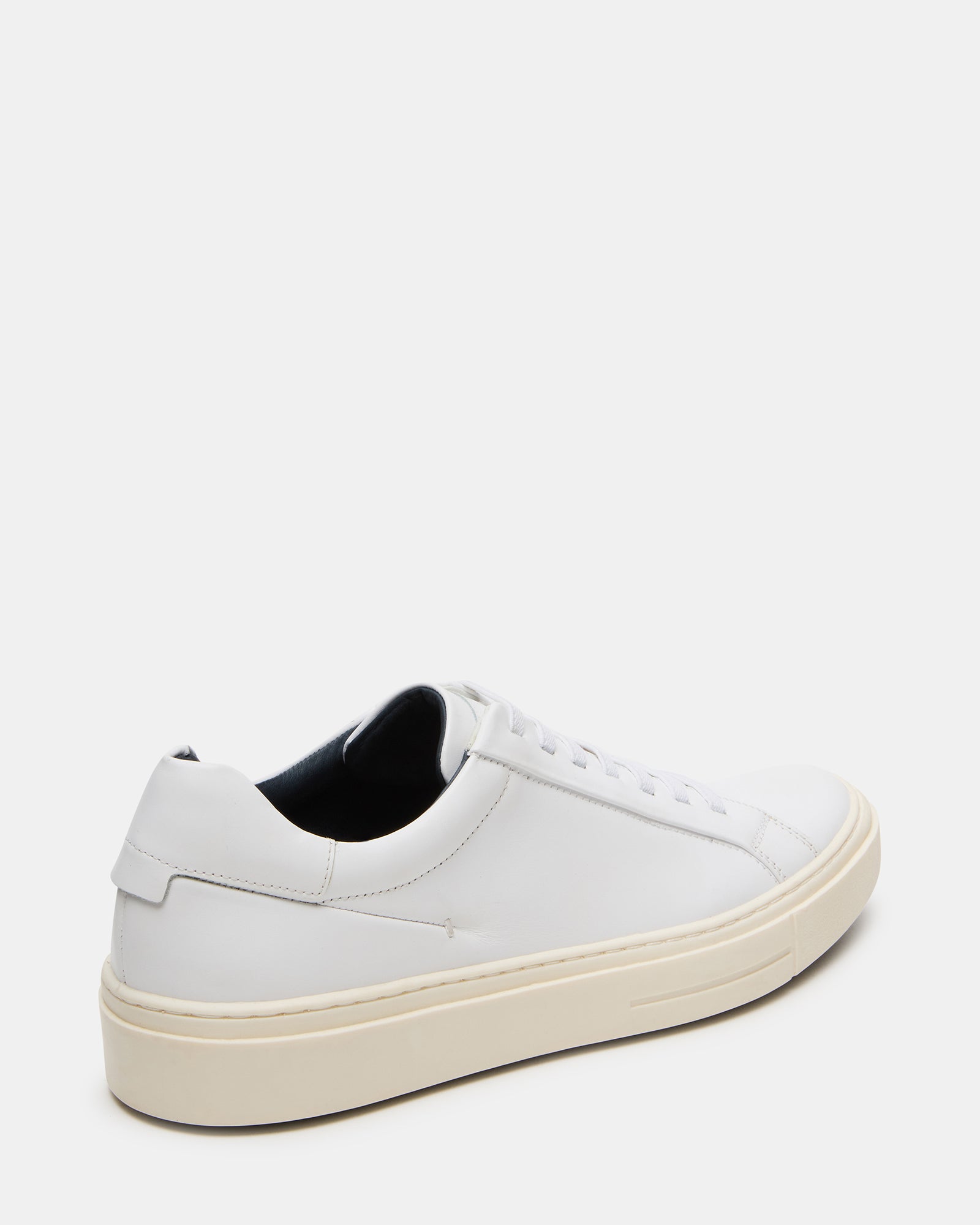 Fashionable white leather sneakers paired with casual clothing for daily wear