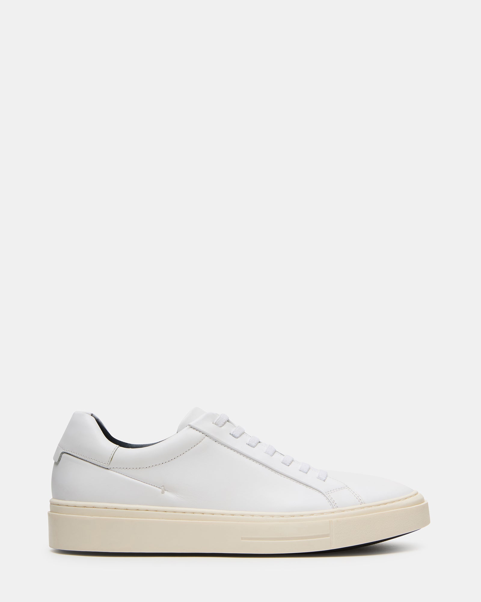 Side view of ZOII white leather sneakers highlighting the sleek design and rubber sole