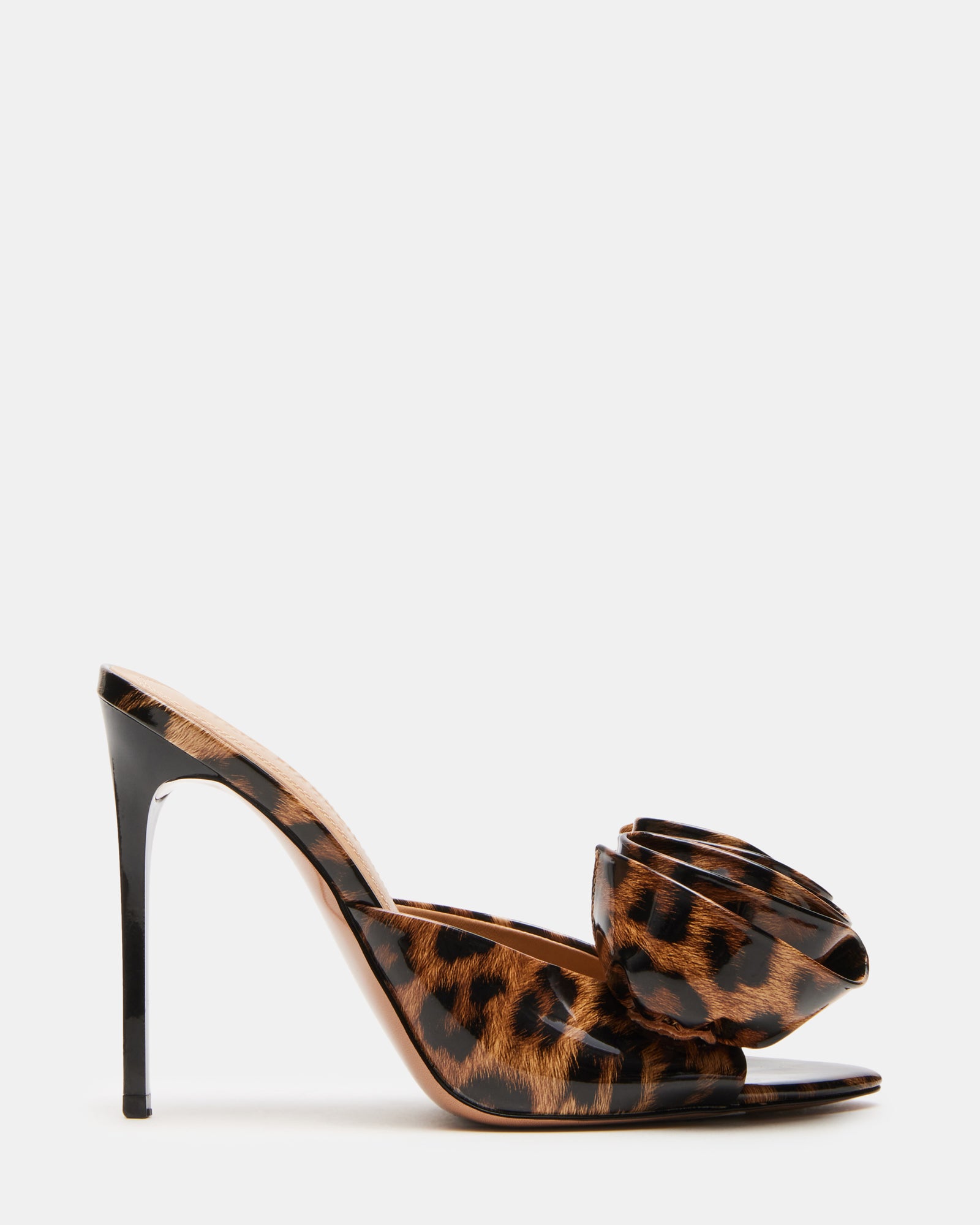 Close-up of leopard patent pointed toe heels on hardwood surface