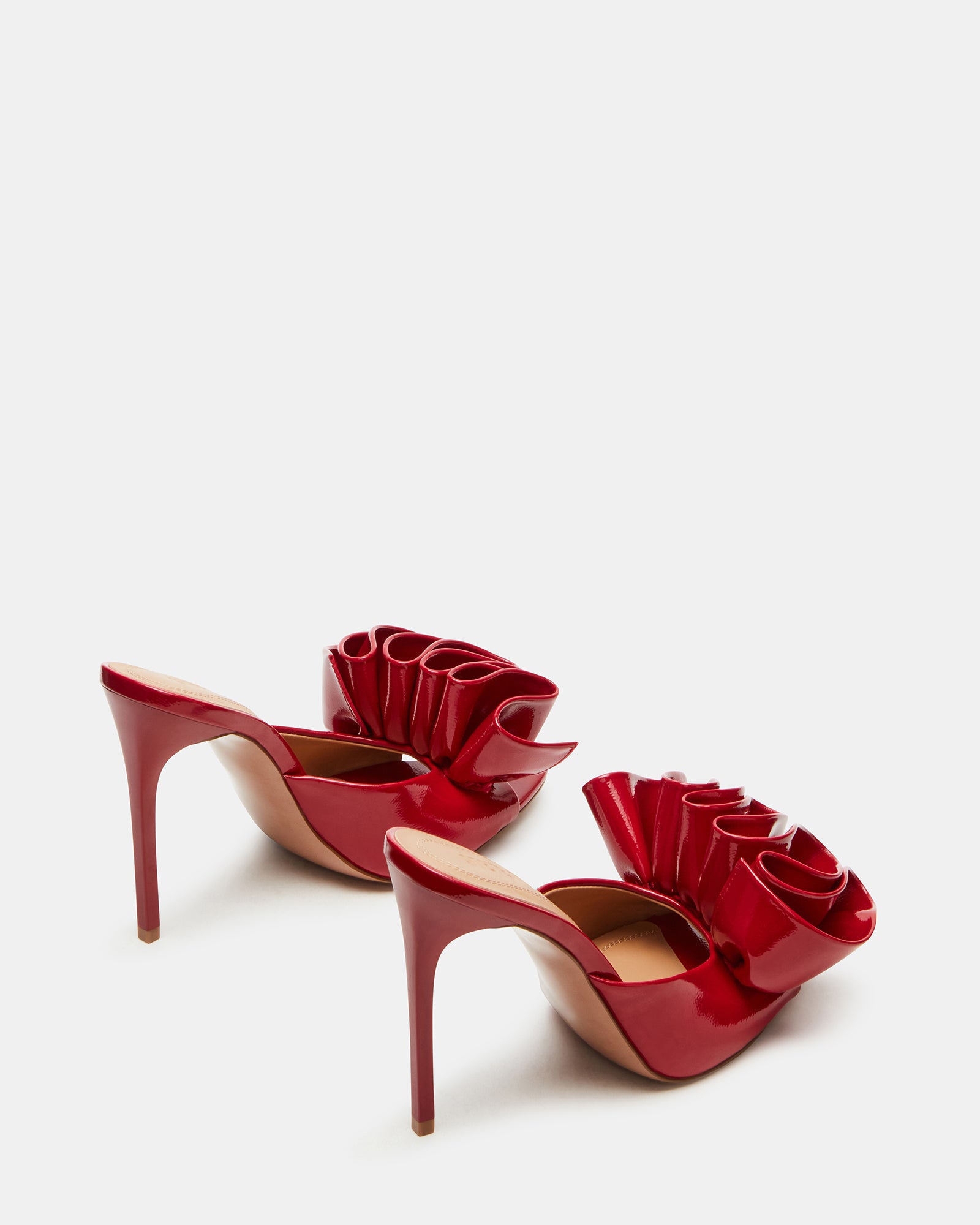 Side angle of red patent heels highlighting the sleek silhouette and 4.5-inch heel