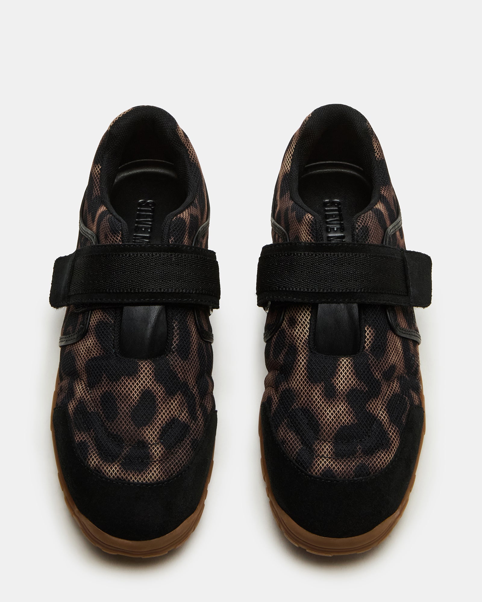 Side view of Mary Jane shoes with Velcro strap on textured sidewalk