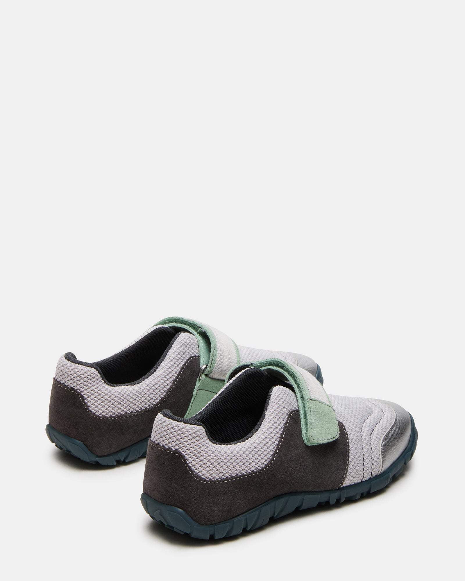 Side view of low top sneakers highlighting the Velcro closure and stylish appearance.