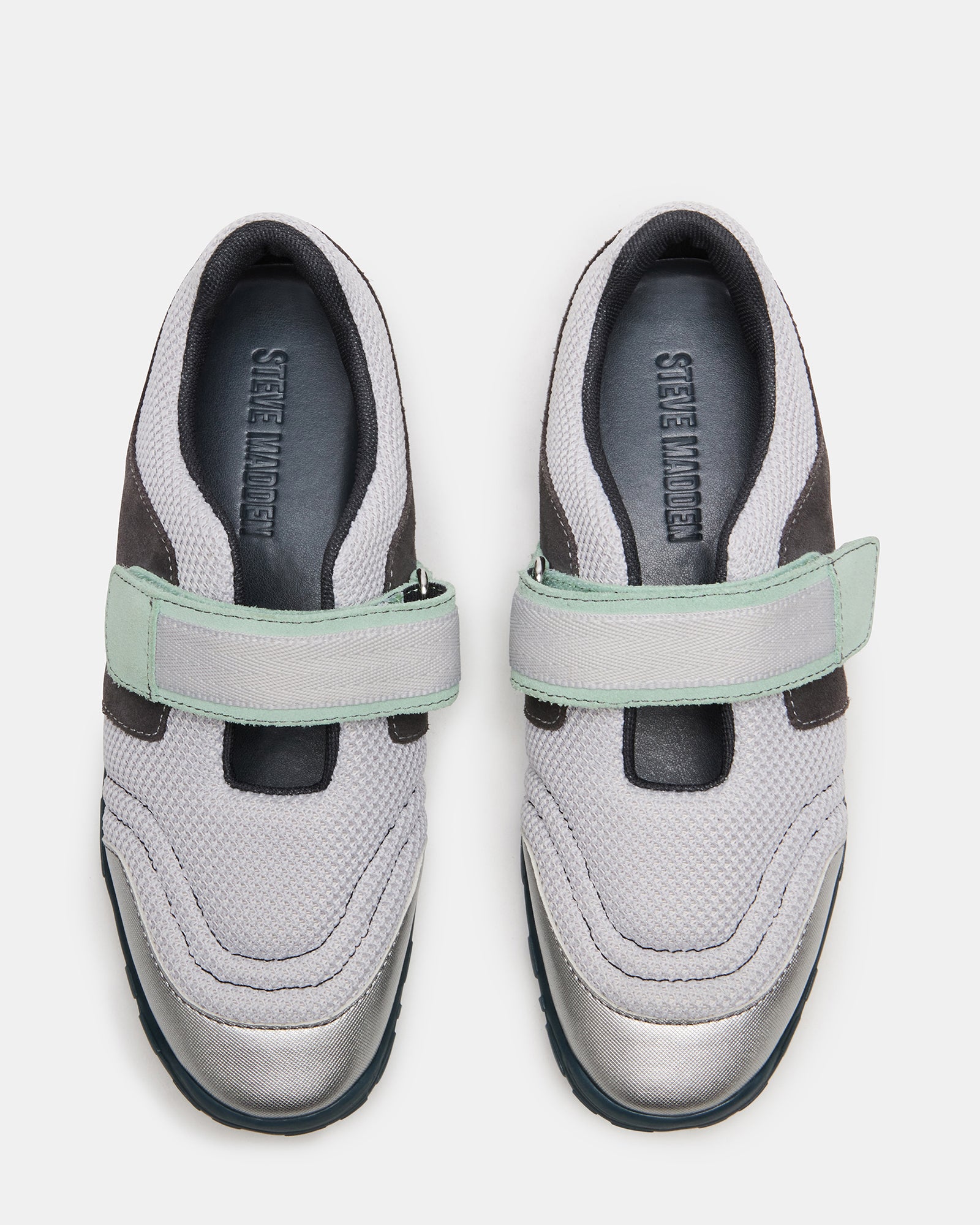 Close-up of silver Velcro Mary Jane sneakers showcasing the rounded toe design.