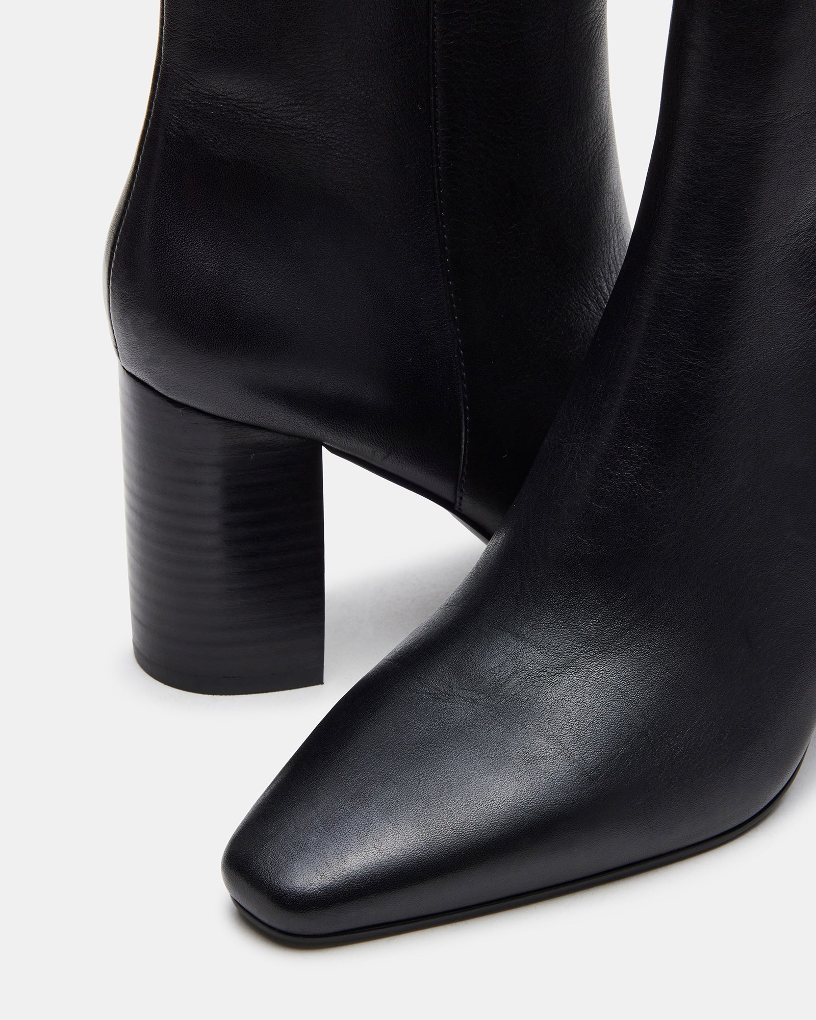 Side view of Aidan black leather block heel ankle booties showcasing the square toe design.