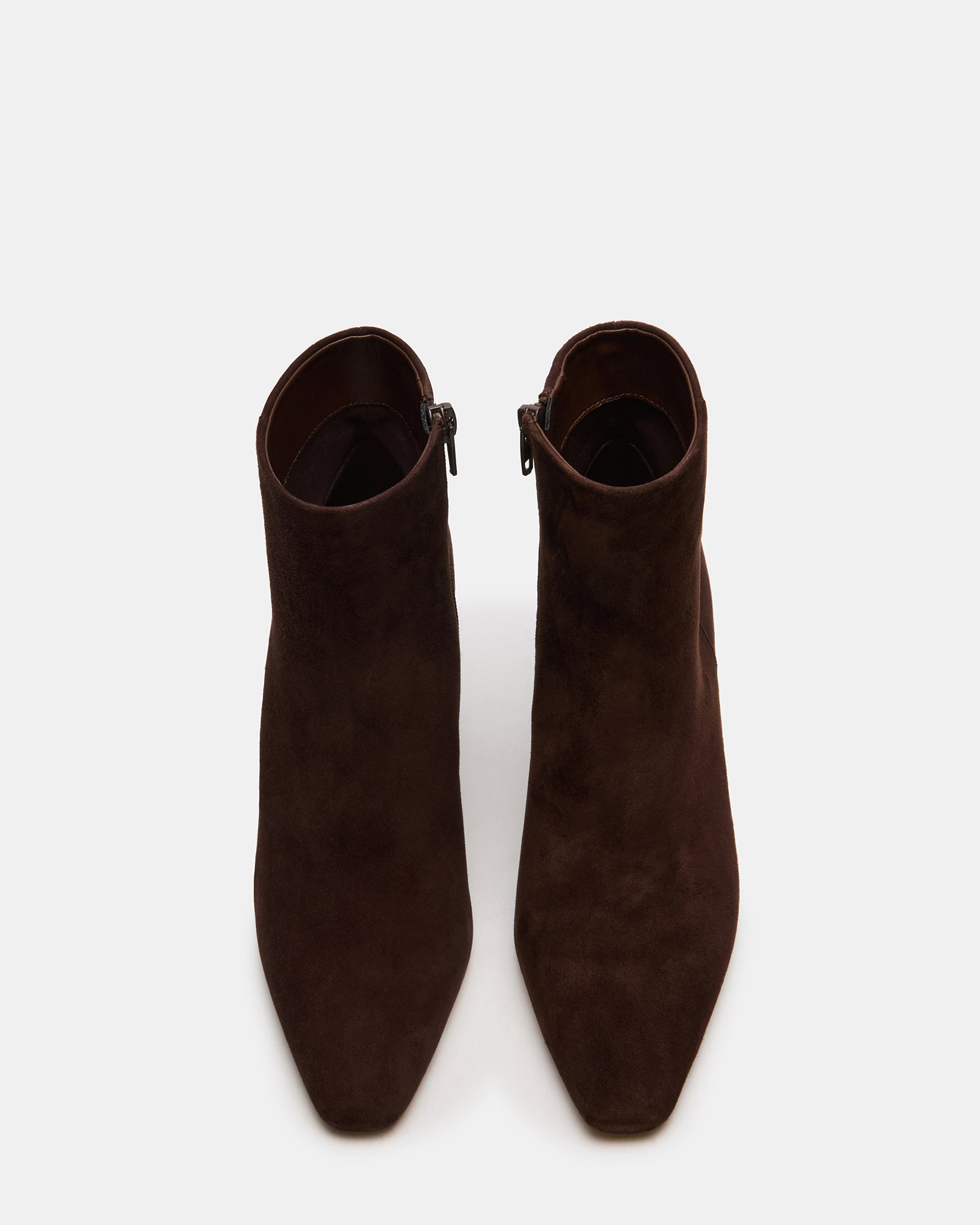 Side view of brown suede booties styled with rolled jeans for a casual look