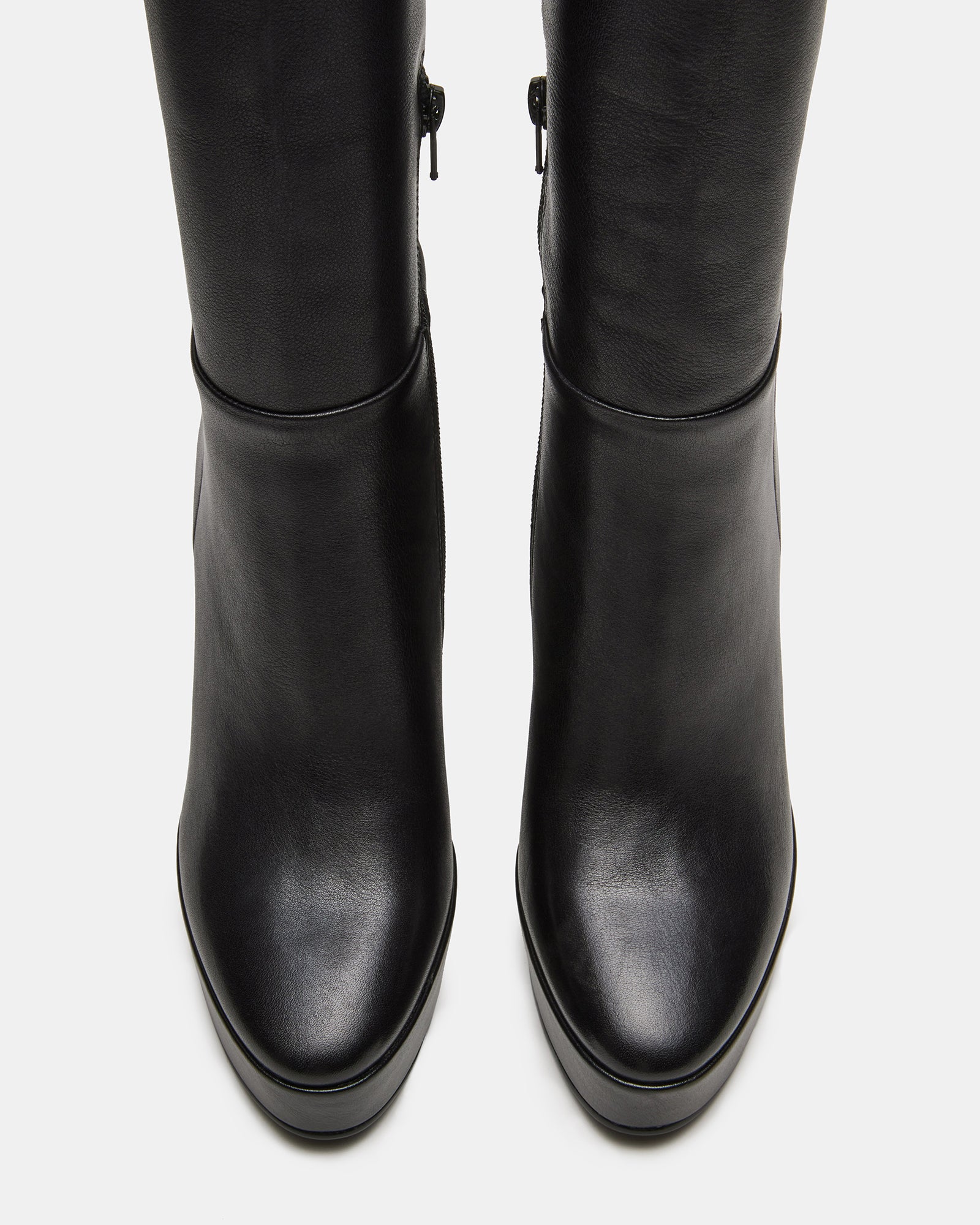 Close-up of platform wedge heel and inner zipper on wide calf knee high boots