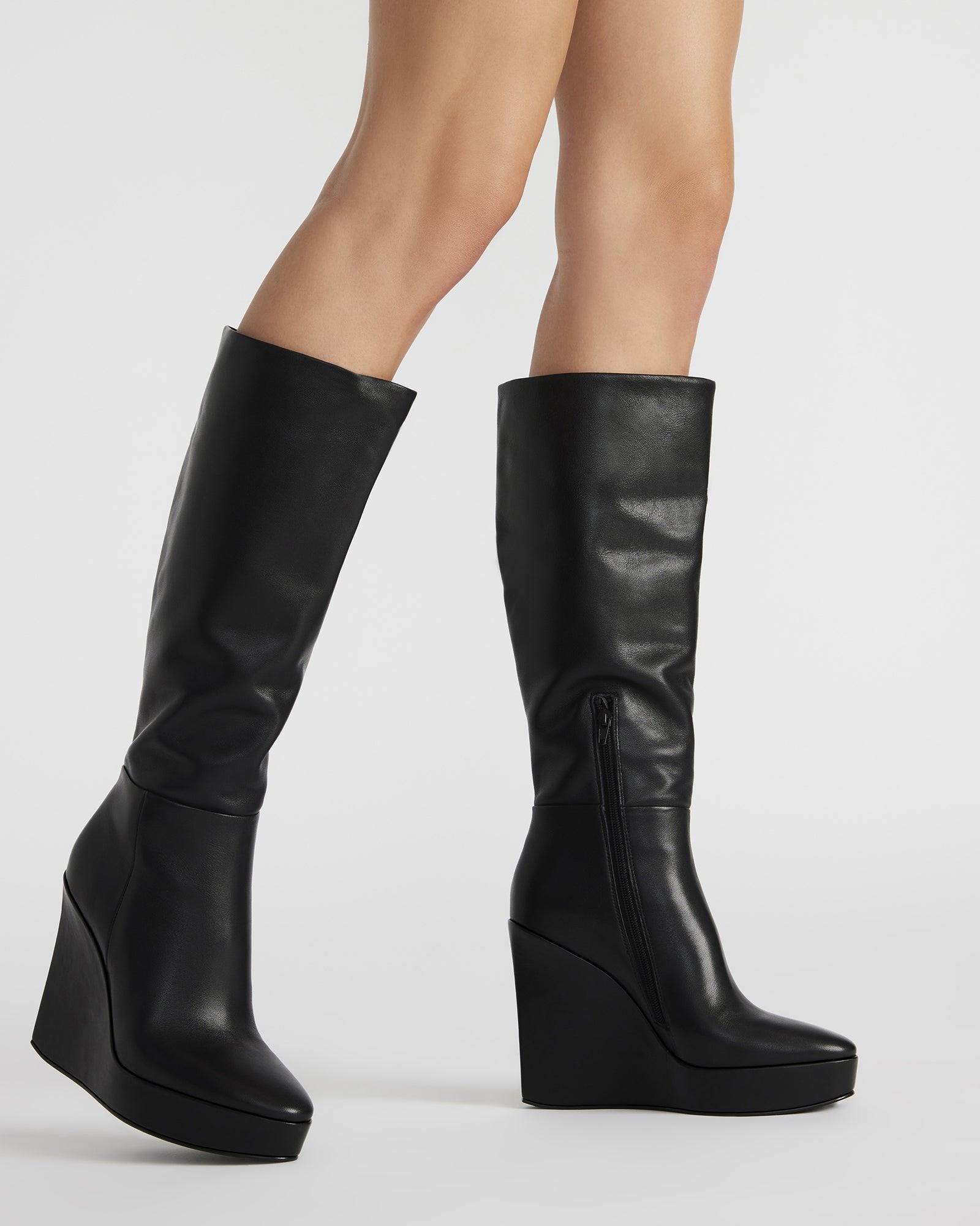 Close-up of platform wedge heel and inner zipper on wide calf knee high boots