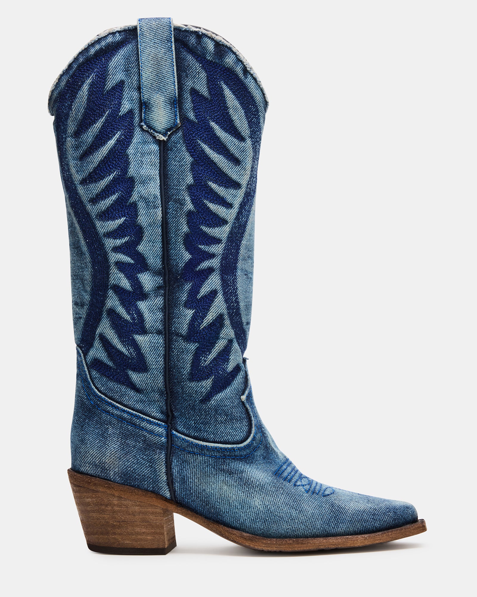 Women's black Western boots side view on rustic porch