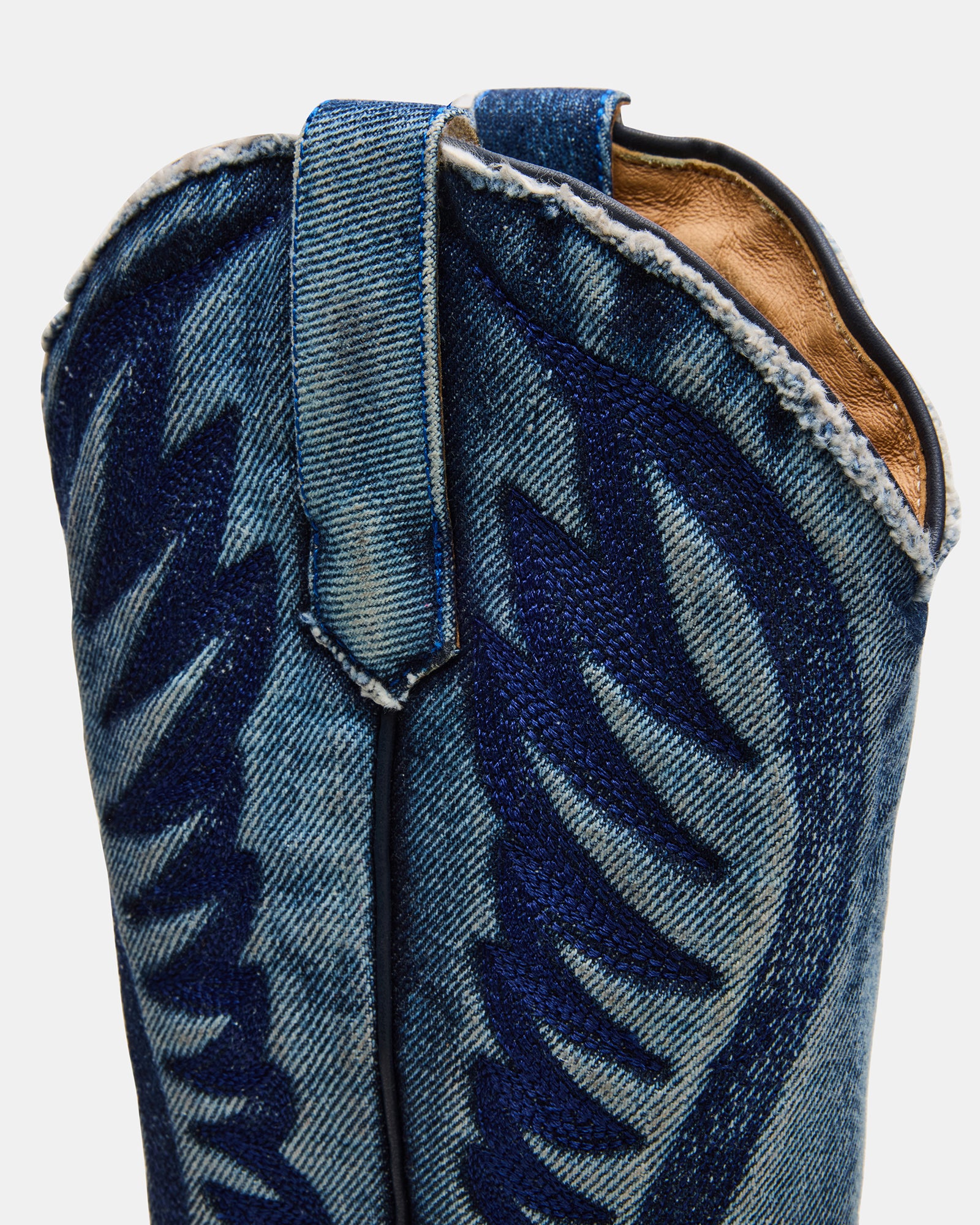 White cowboy boots styled with denim for a Texas-inspired look