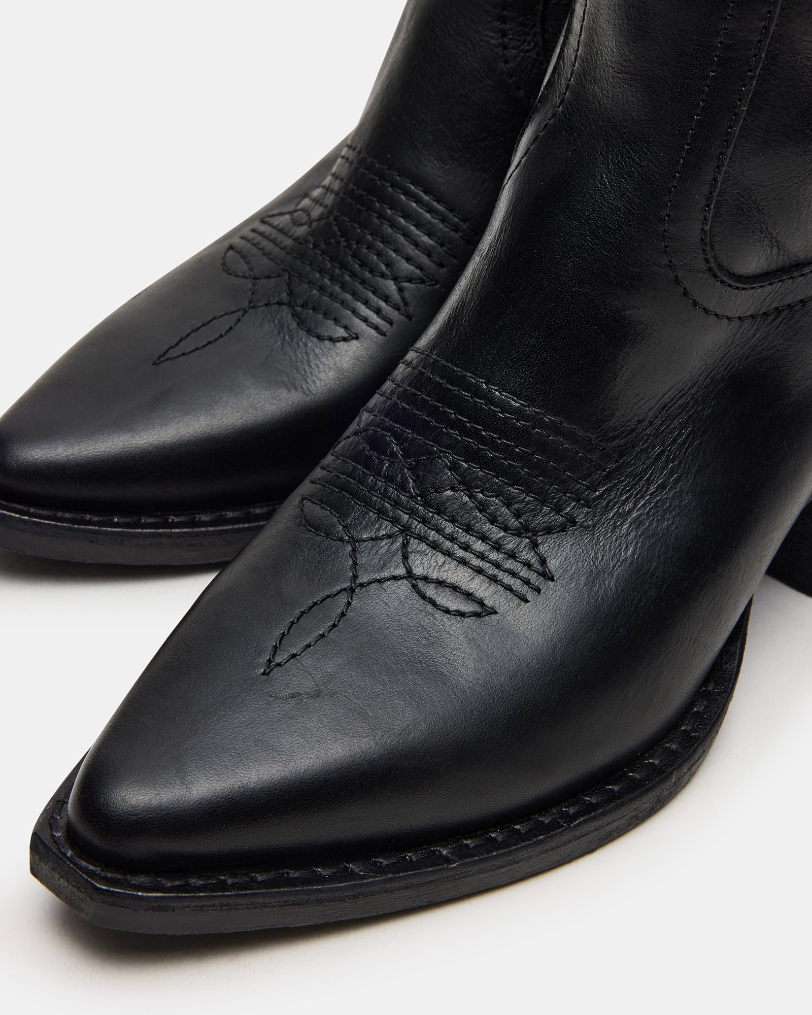 Albany black cowboy boots worn with a casual outfit outdoors.