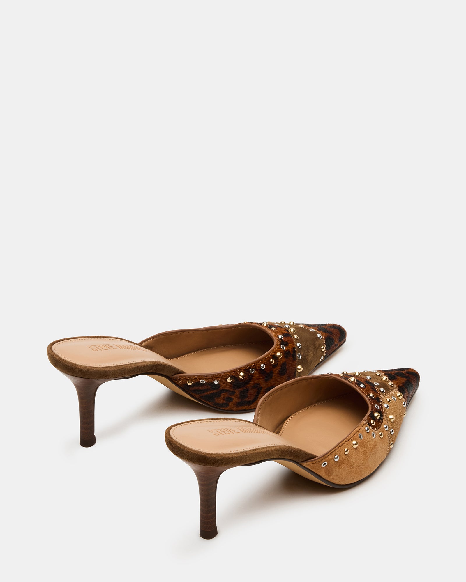 Close-up of ALEXI mule heels highlighting the premium suede and textile materials.