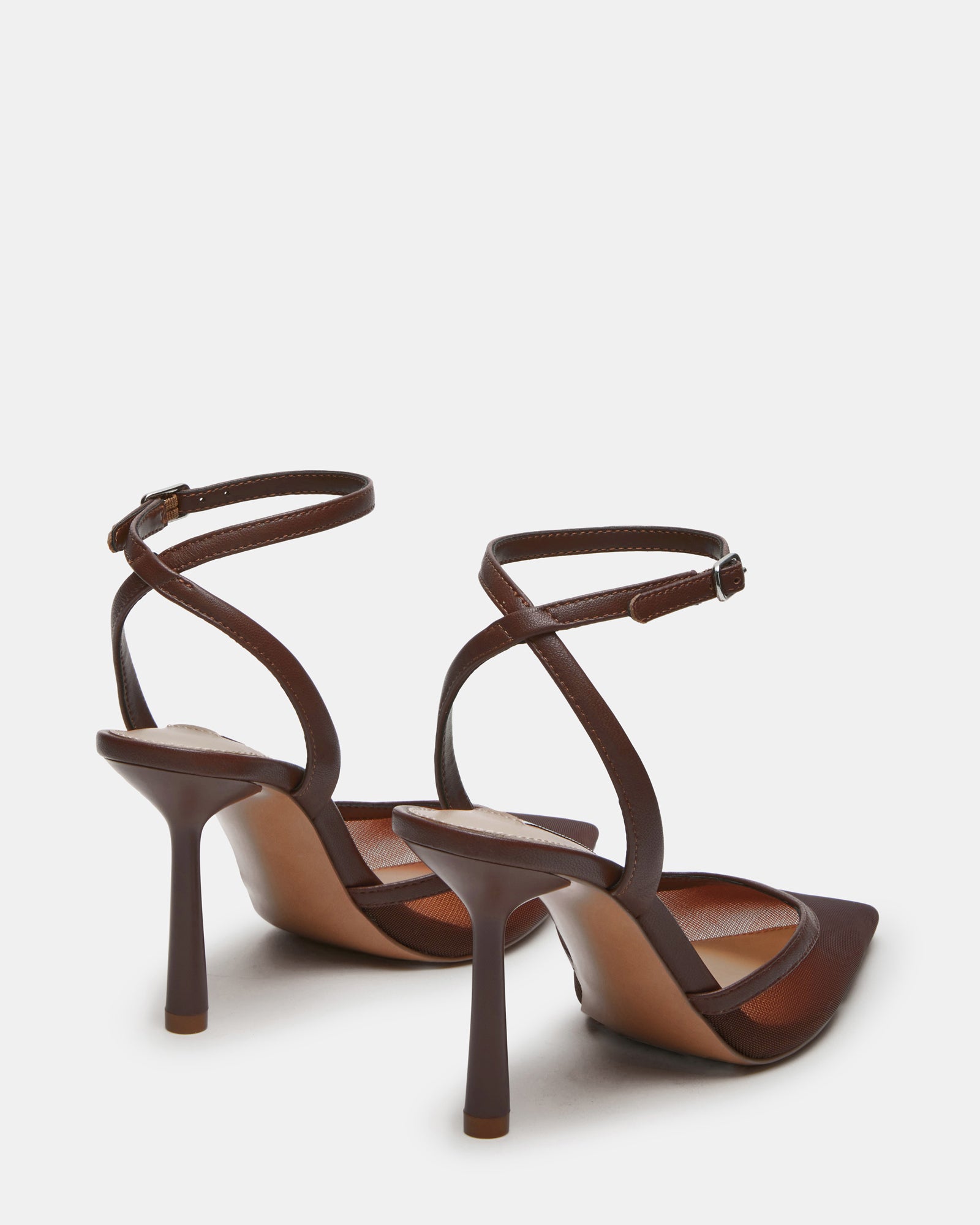 Model wearing elegant pointed toe pumps at a stylish event