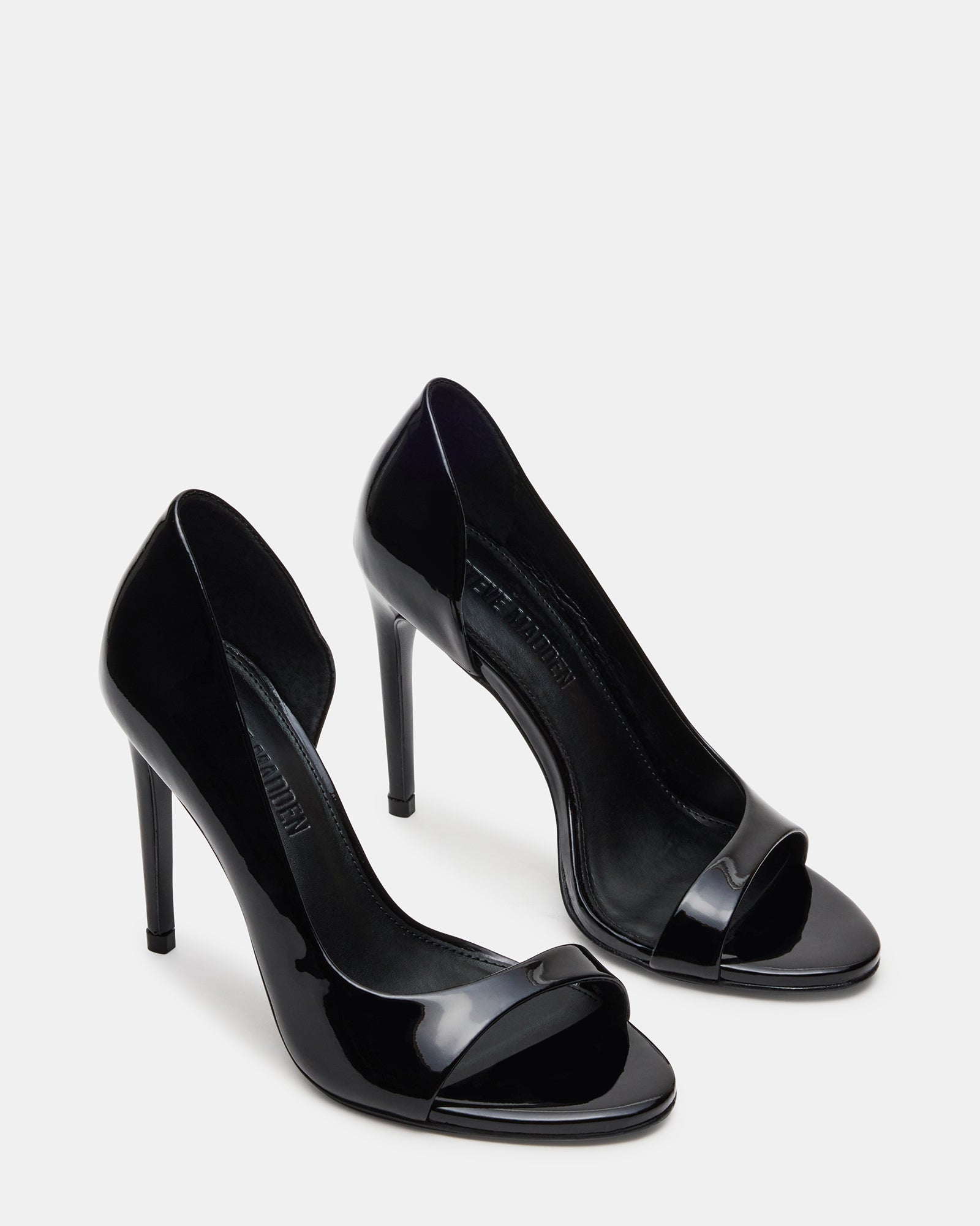 Model wearing sleek black open toe heels for an evening event