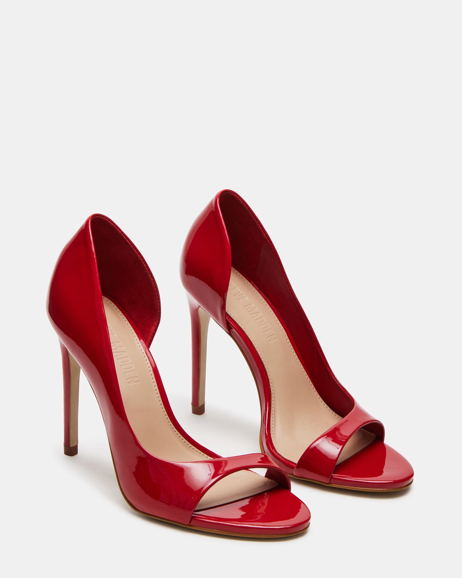 Lifestyle shot of womens pink high heel shoes worn with a cocktail dress