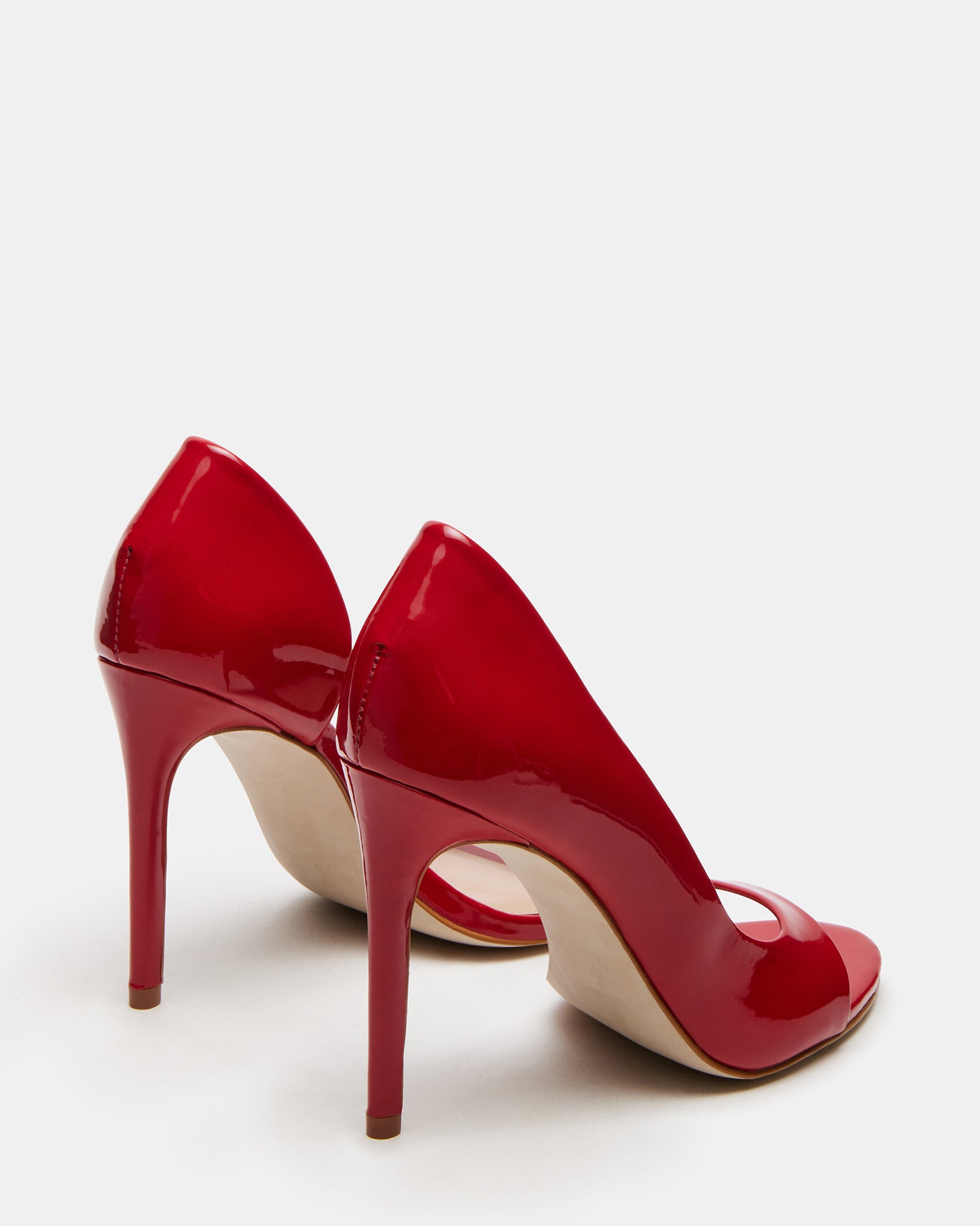 Lifestyle shot of womens pink high heel shoes worn with a cocktail dress
