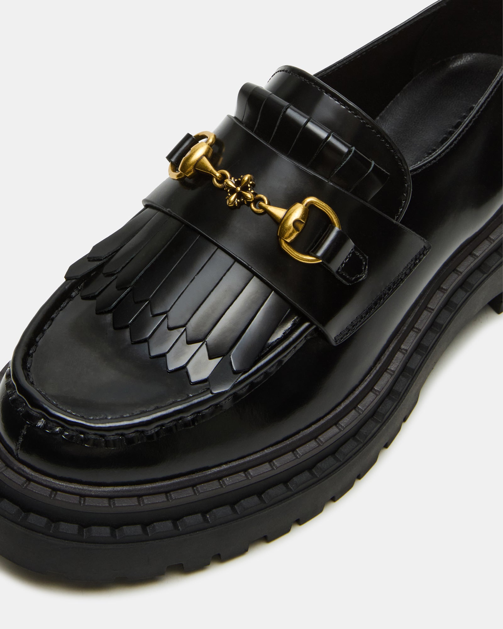 Stylish women’s black leather loafers paired with jeans for everyday wear