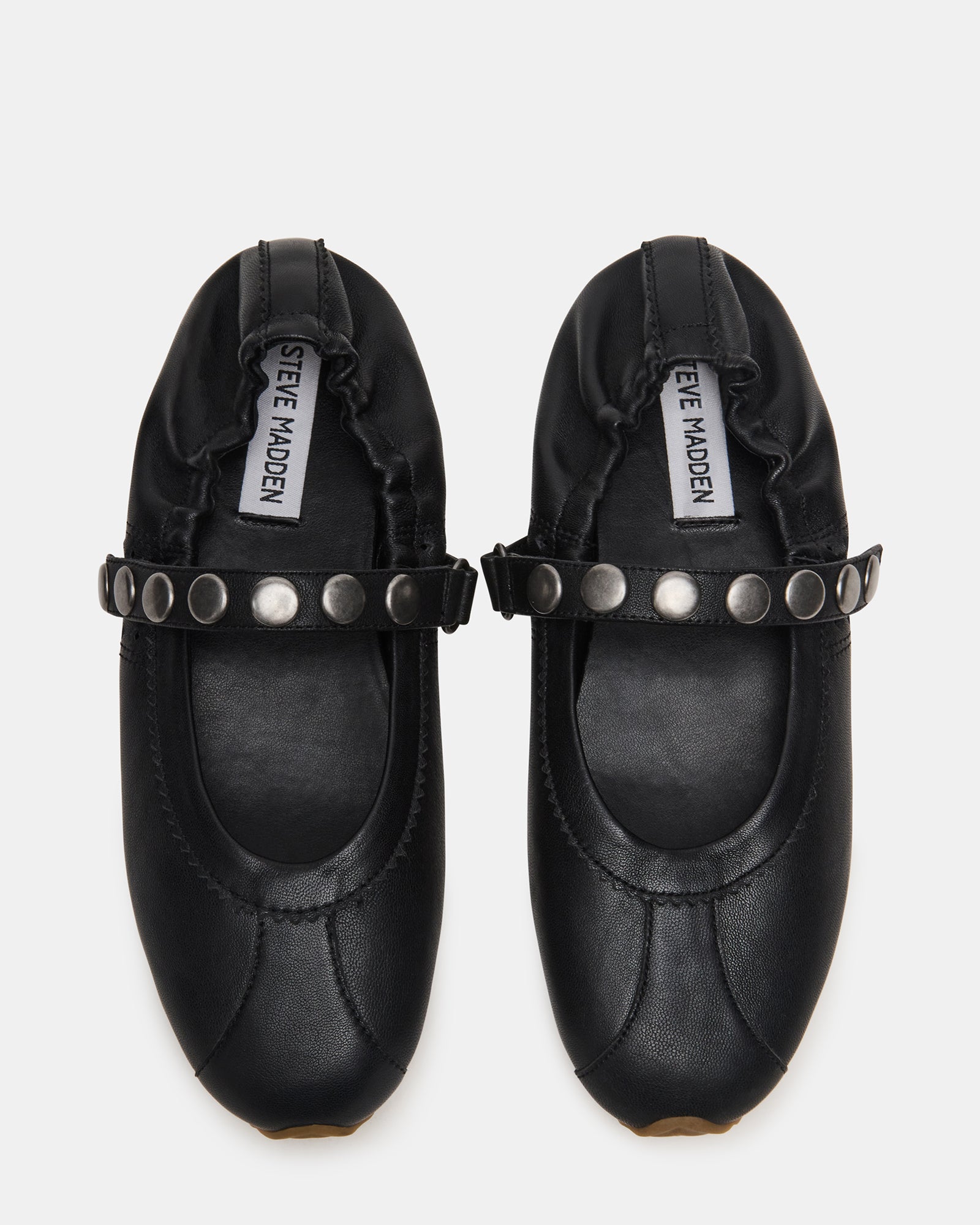 Black Mary Jane shoes displayed on a stylish surface.