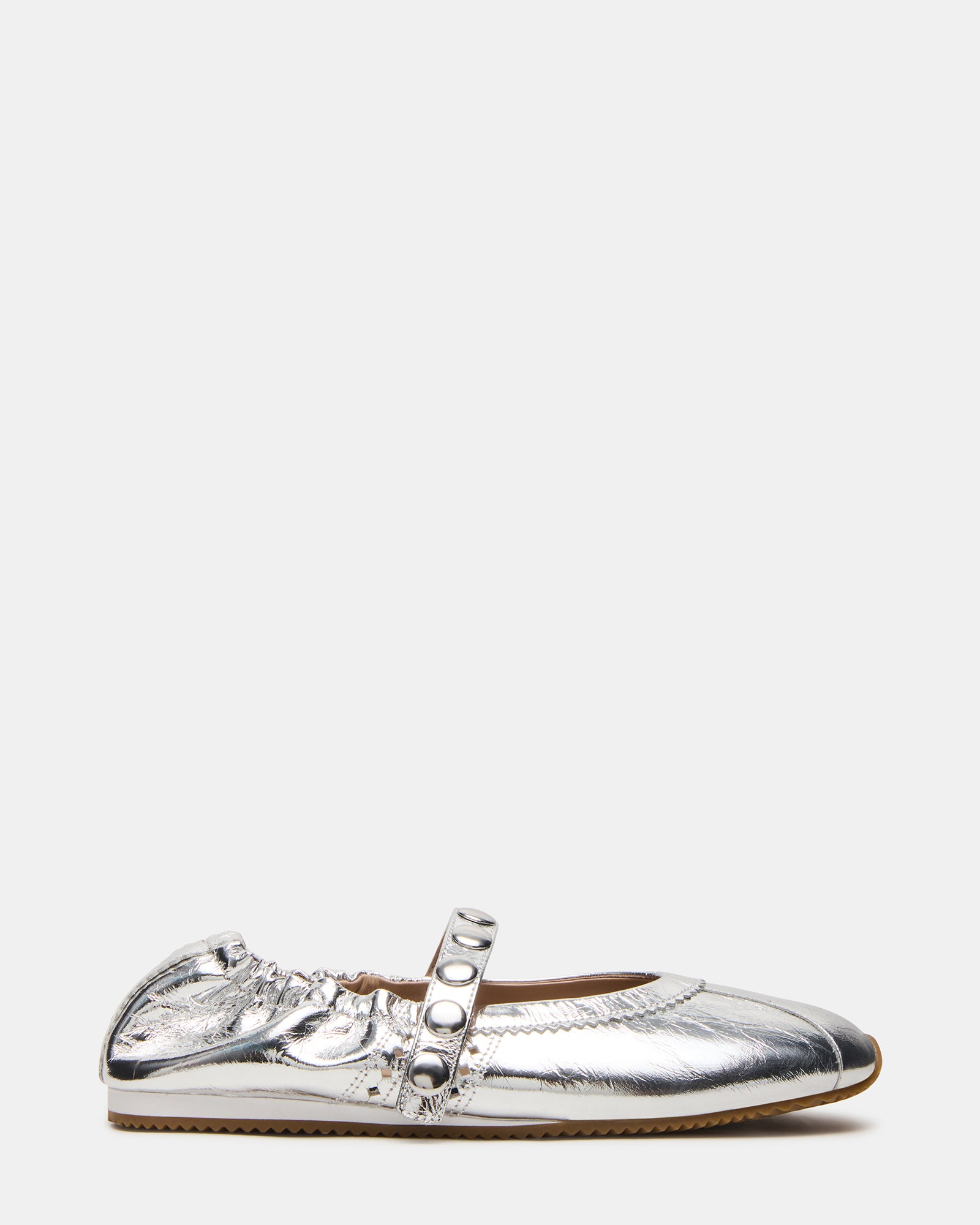 Side view of Anaya silver leather Mary Jane flats on a wooden floor.