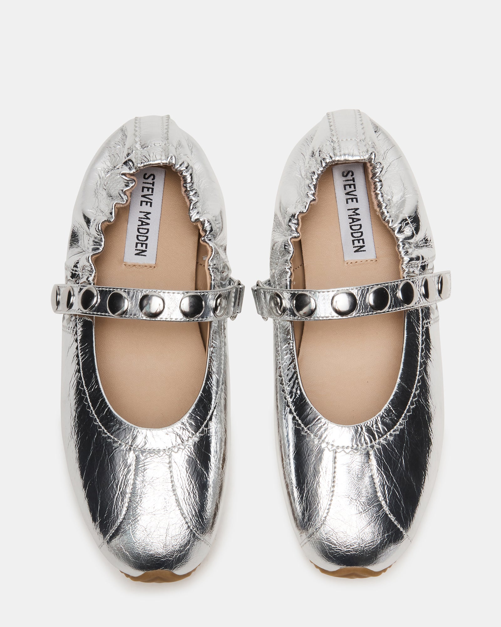 Side view of Anaya silver leather Mary Jane flats on a wooden floor.