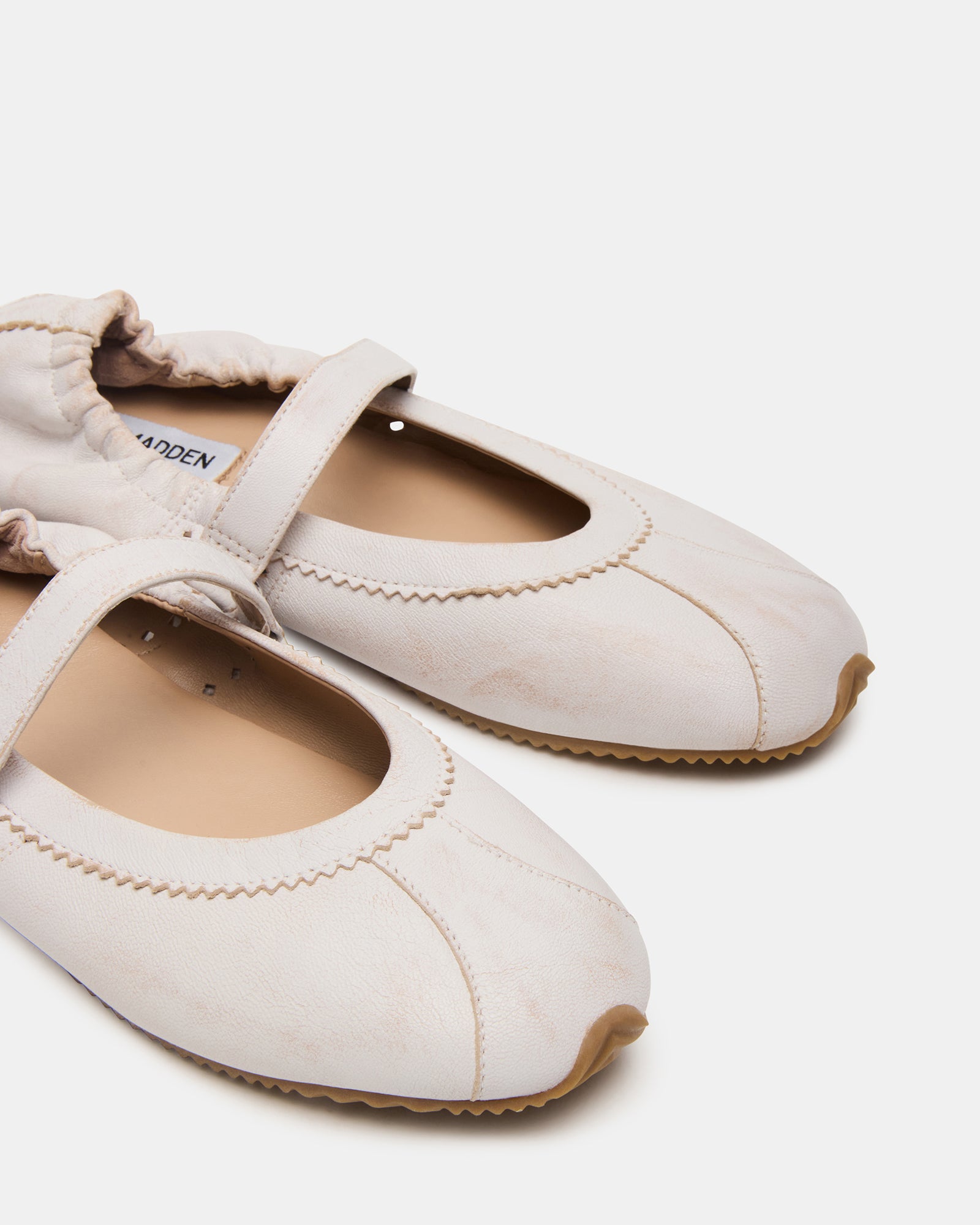 Top-down shot of red ballet flats styled with denim for a casual weekend look