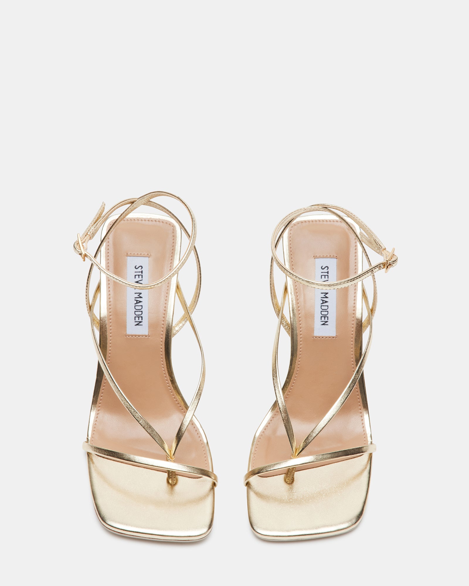Side angle of ANNIE CHAMPAGNE strappy stiletto heels worn with officewear.