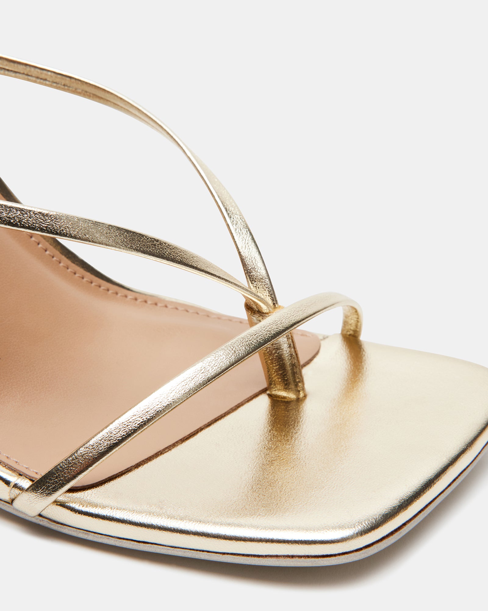 Close-up of vegan leather straps and stiletto heel from ANNIE CHAMPAGNE shoes.