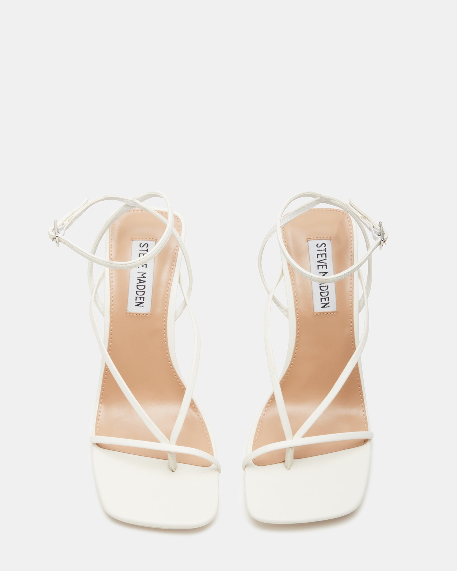 Annie white stiletto heels styled with a chic outfit for a night out.