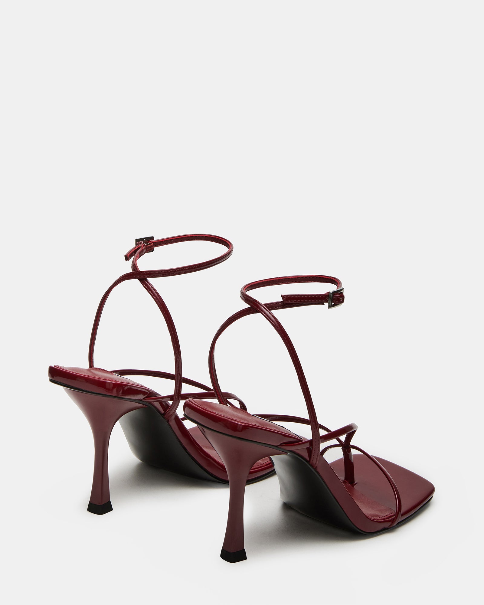 Model wearing light pink high heel shoes in upscale urban setting