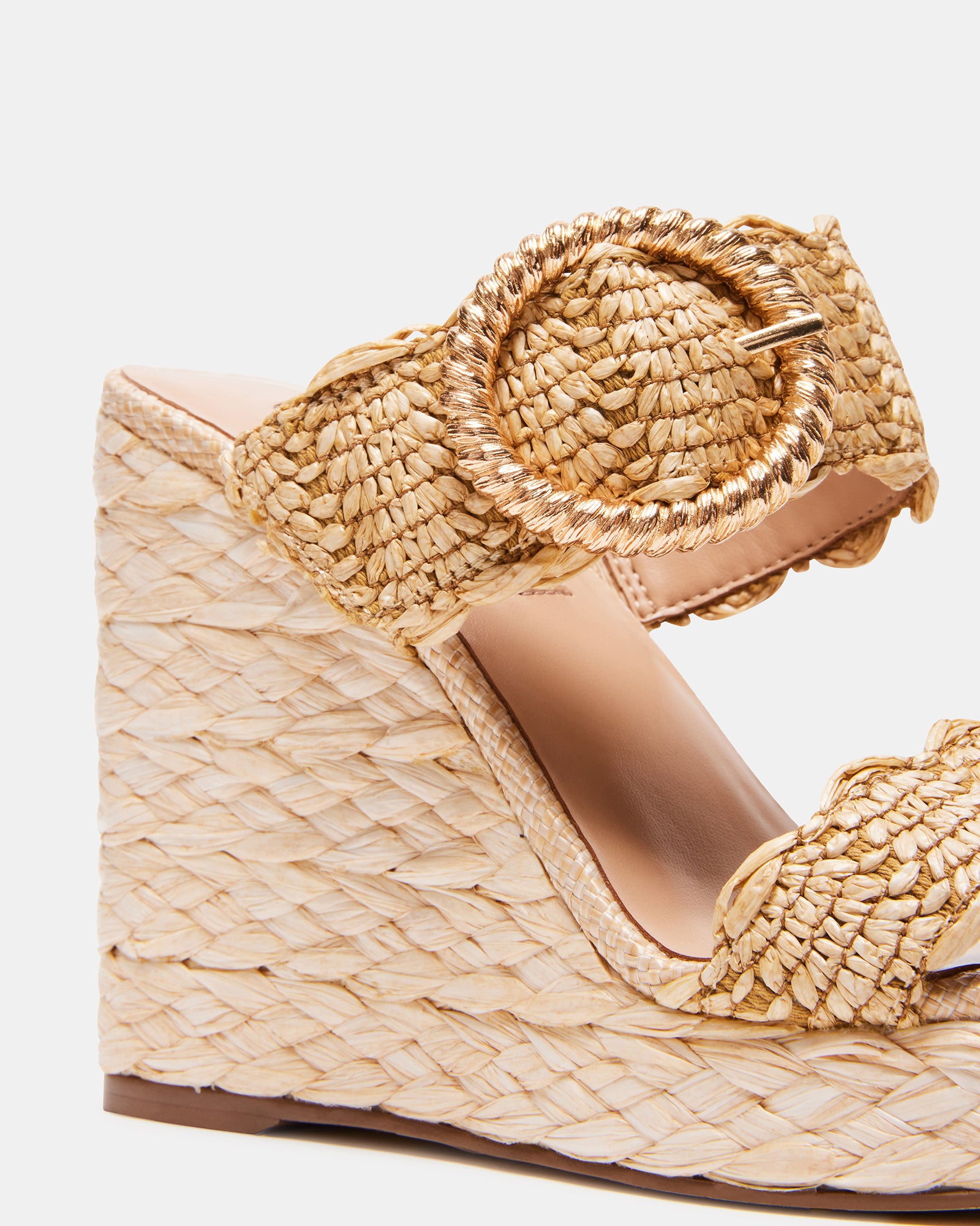 Close-up of raffia wedge sandals showing braided finish and square toe design