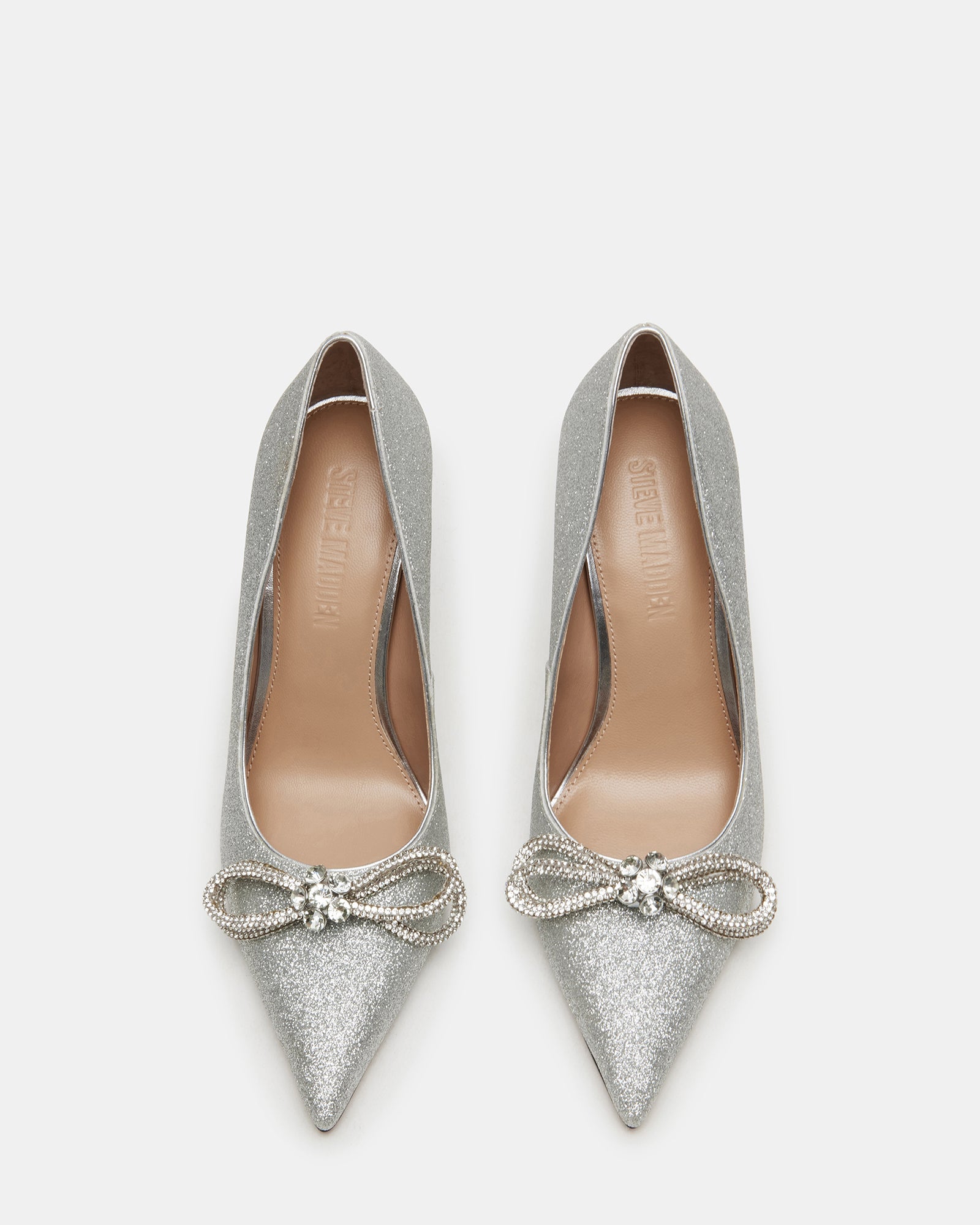 Silver platform heels with bow detail, worn with evening dress