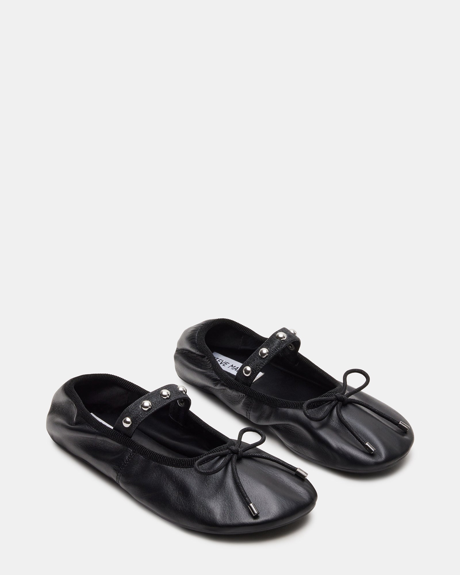 Close-up of the leather texture and stitching on the ballet flats