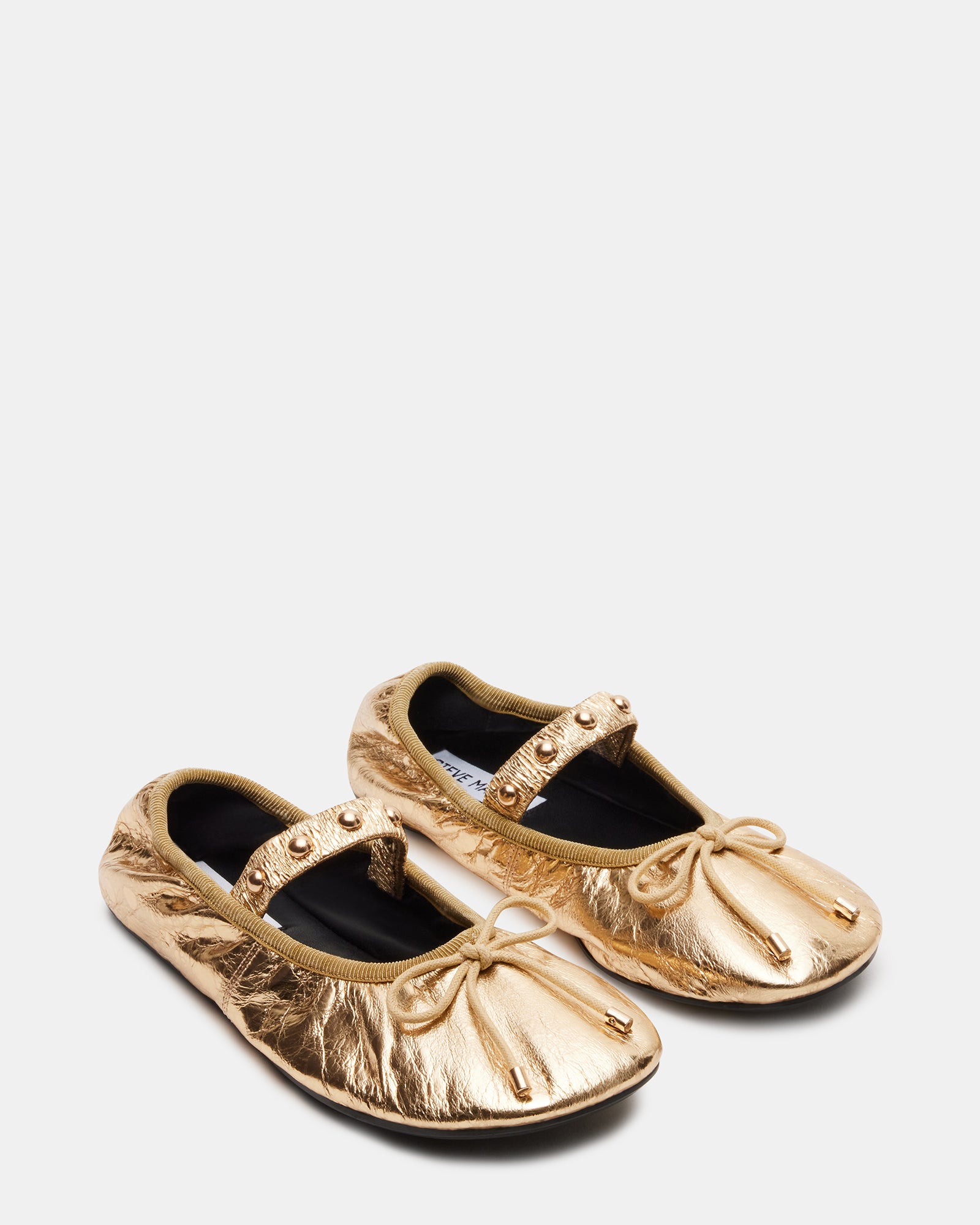 Close-up of the bow detail on Arabella gold ballet flats.