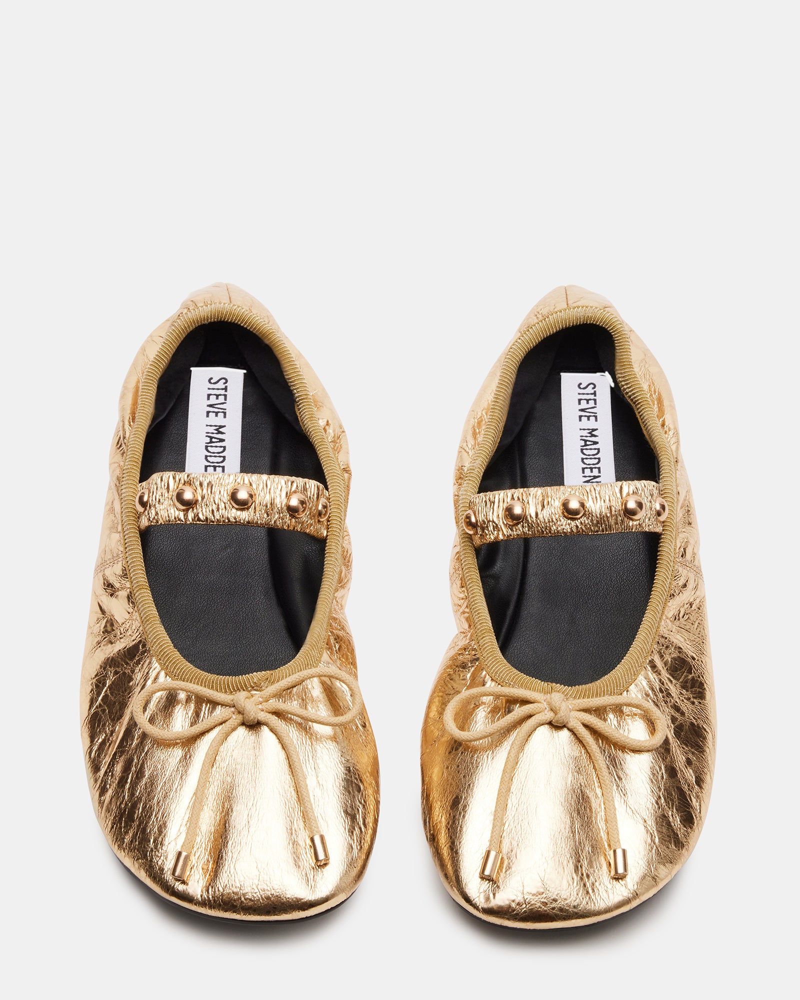 Elegant side view of Arabella gold ballet flats showcasing studs.