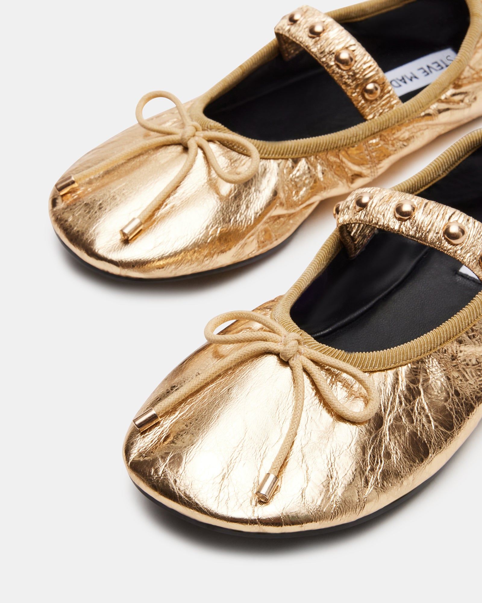 Arabella gold ballet flats styled with a chic outfit.
