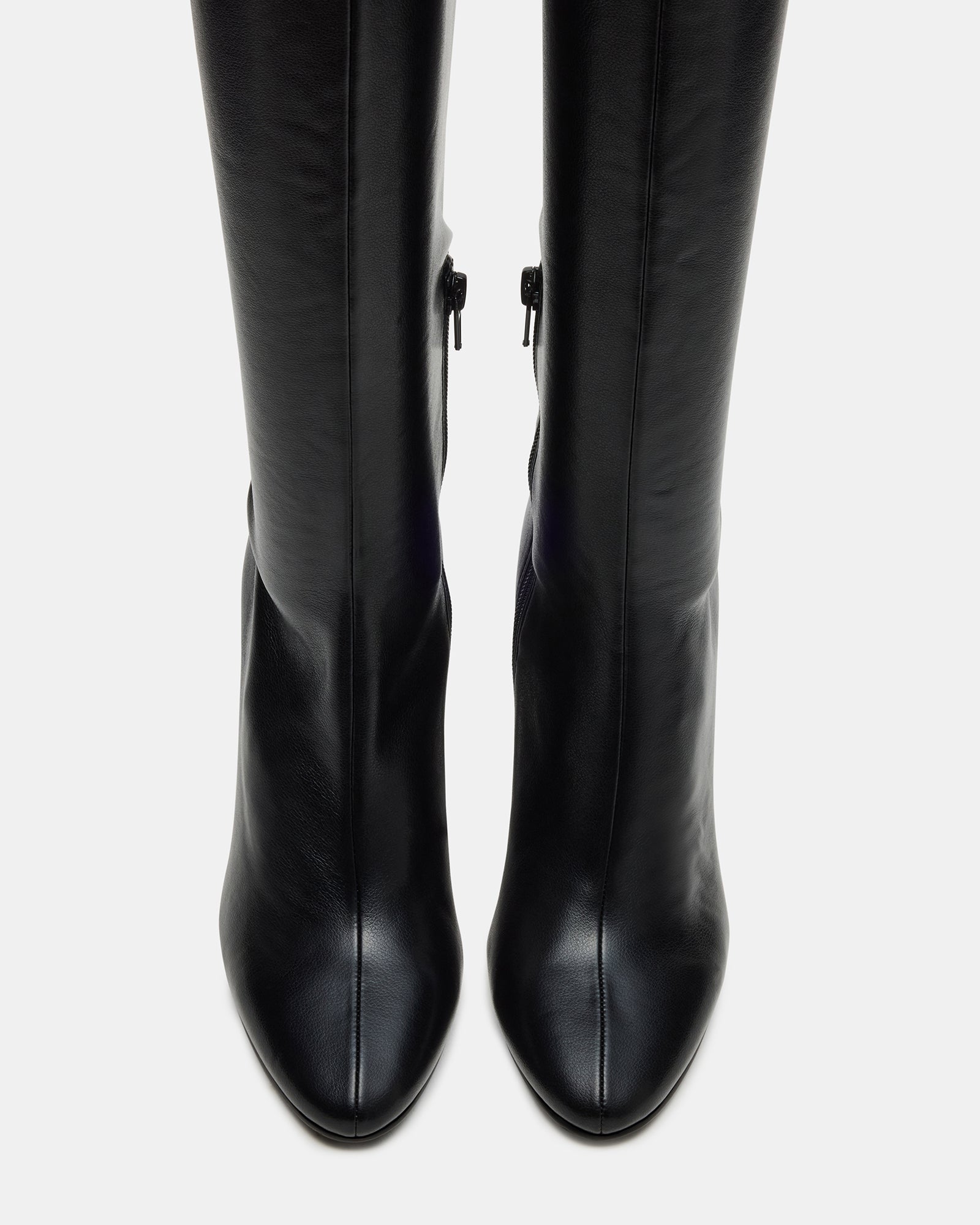 Black wide calf boots styled with skinny jeans for a chic look