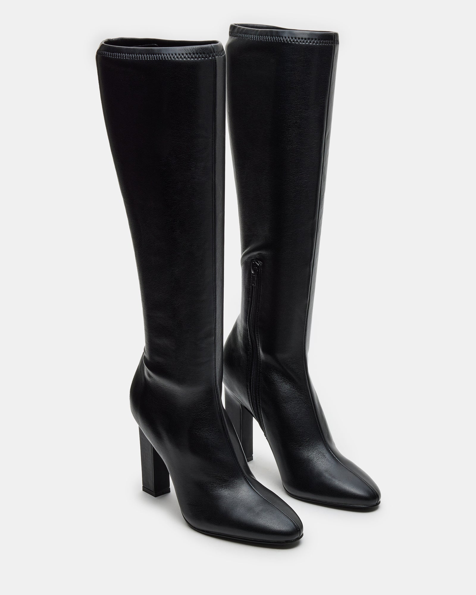 Back view showing zipper closure and fit of fashion boots on model