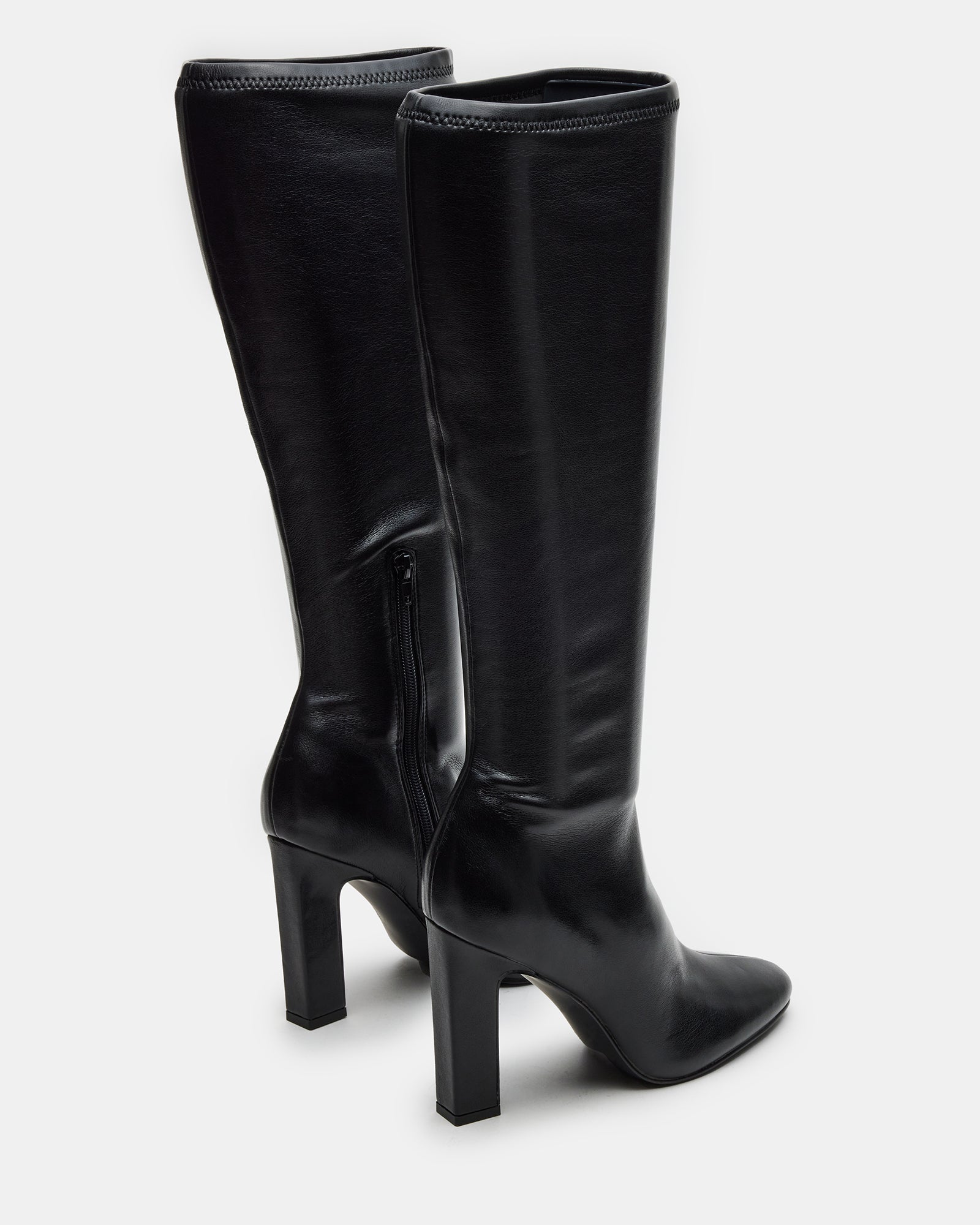 Back view showing zipper closure and fit of fashion boots on model