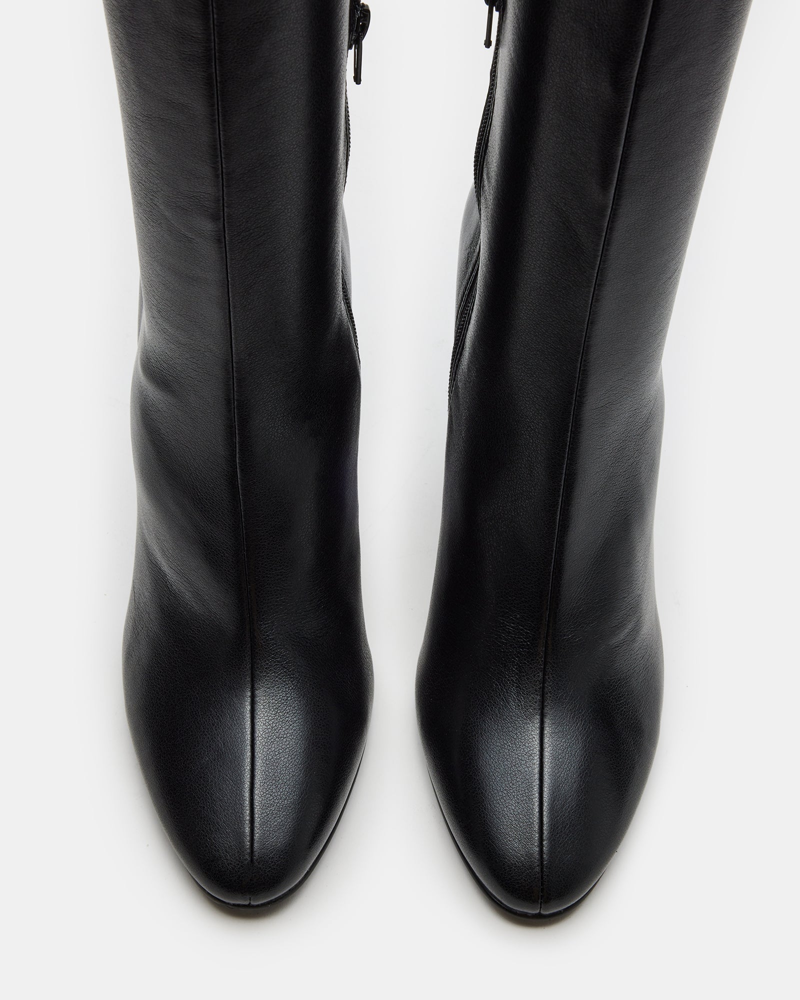 Front view of heeled boots styled with winter coat on Salt Lake sidewalk