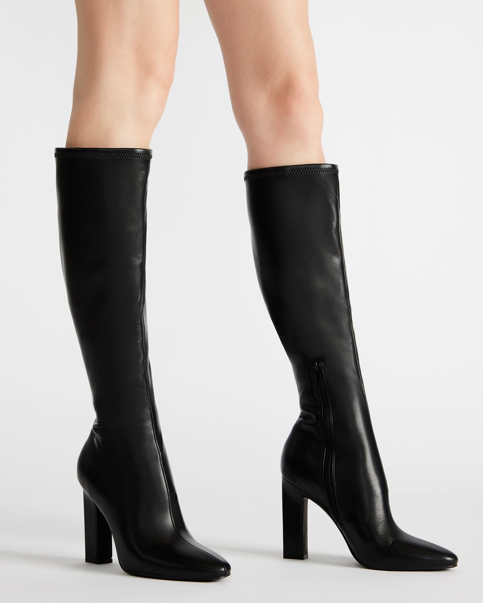 Front view of heeled boots styled with winter coat on Salt Lake sidewalk