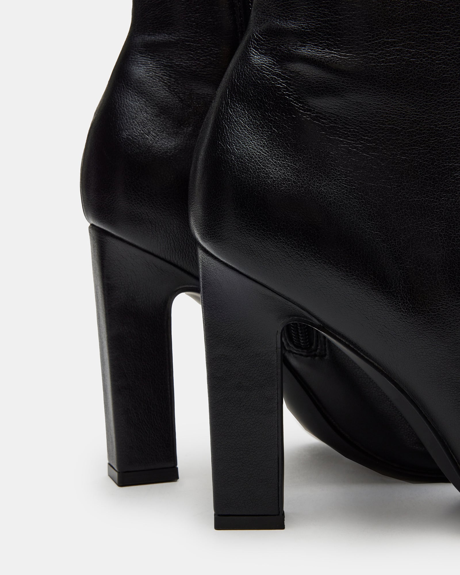 Side angle of the knee-high black boots showing heel and shaft details